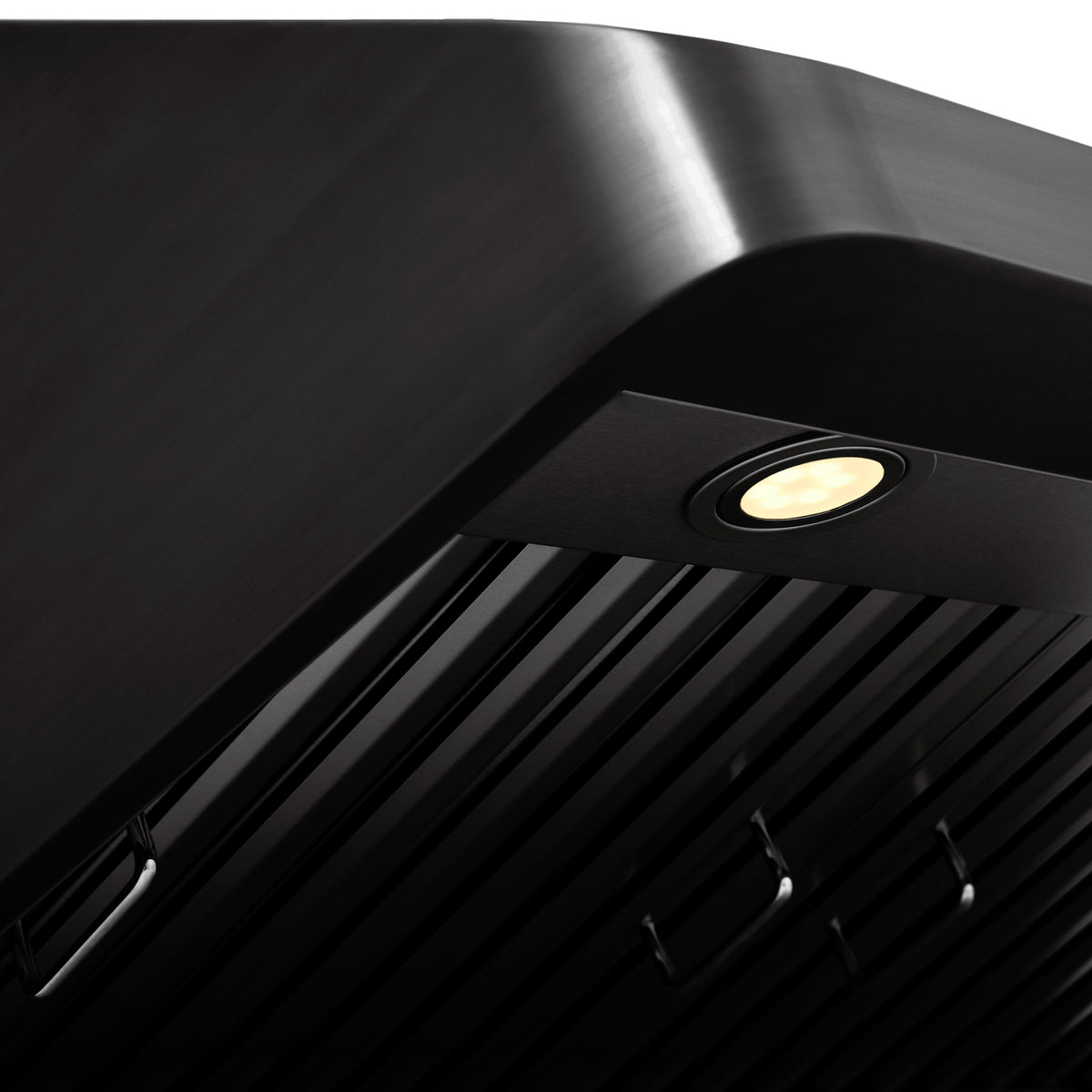 Black stainless ducted range hood with glowing LED light and slatted baffle