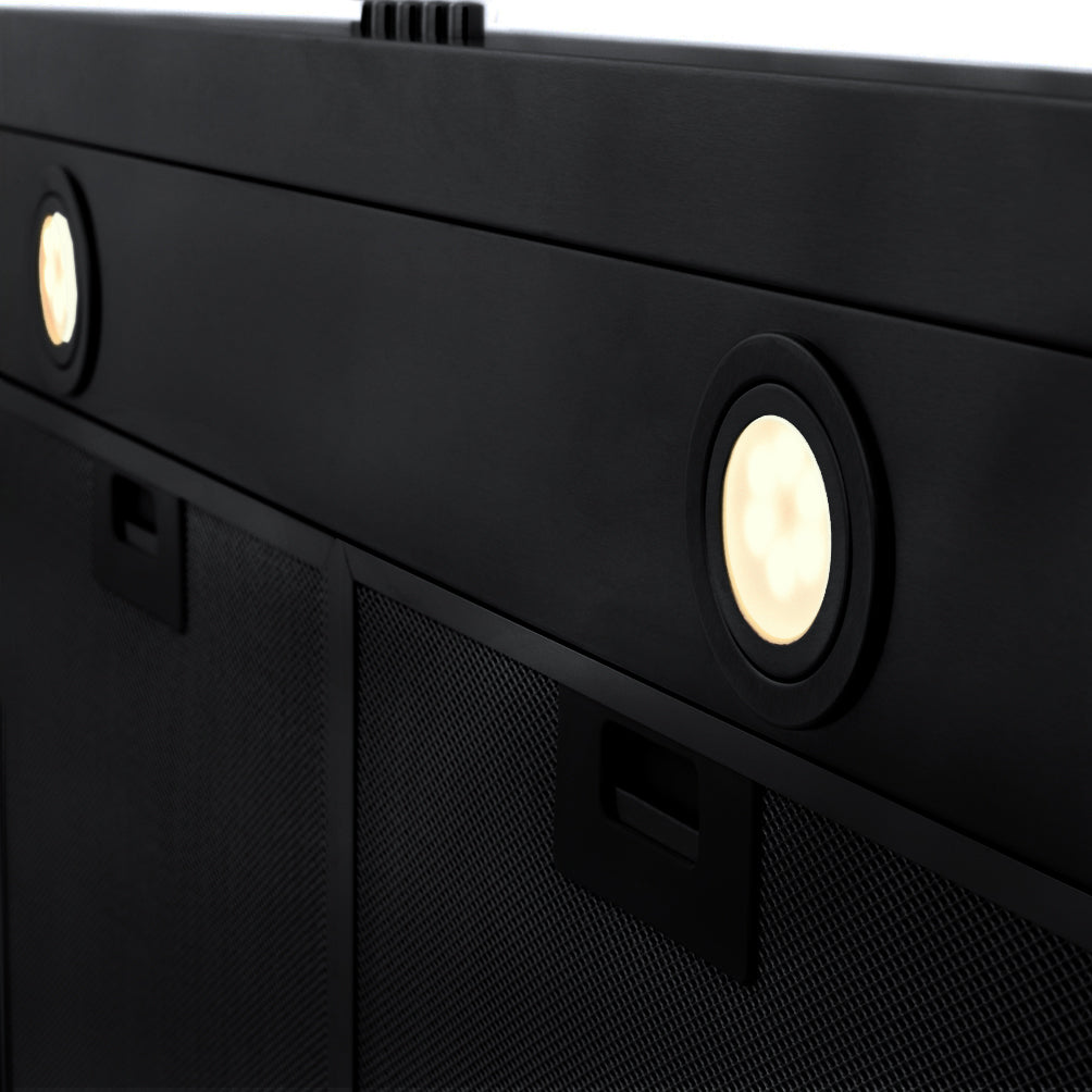 Black under-cabinet range hood with round lights and vented filter panels