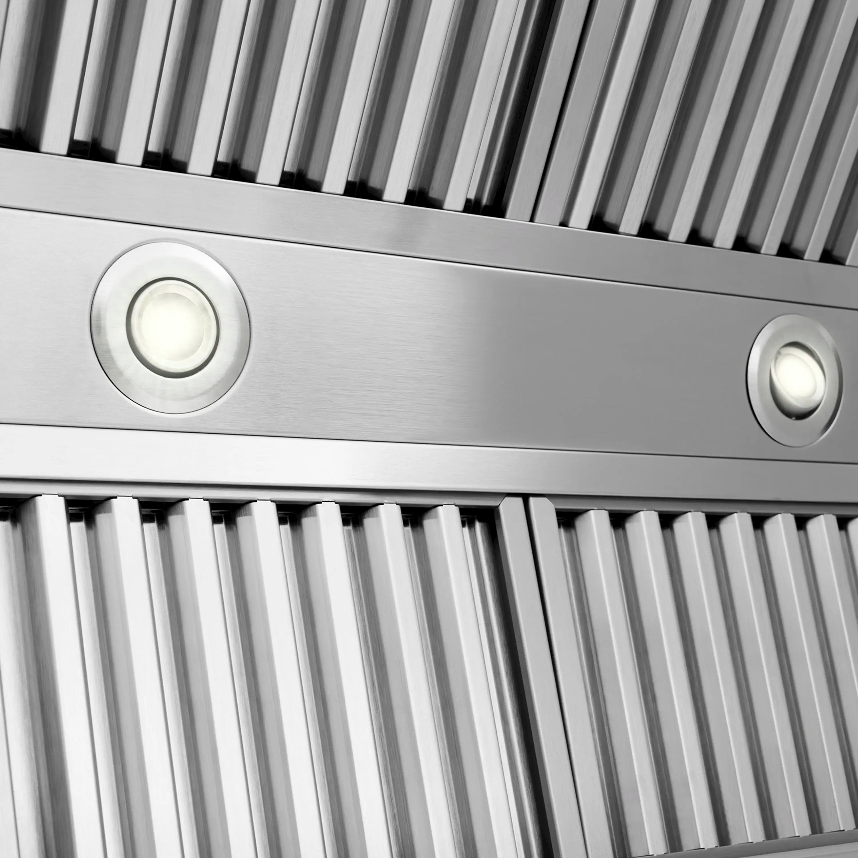 Stainless vent hood front with vertical filters and round control knobs