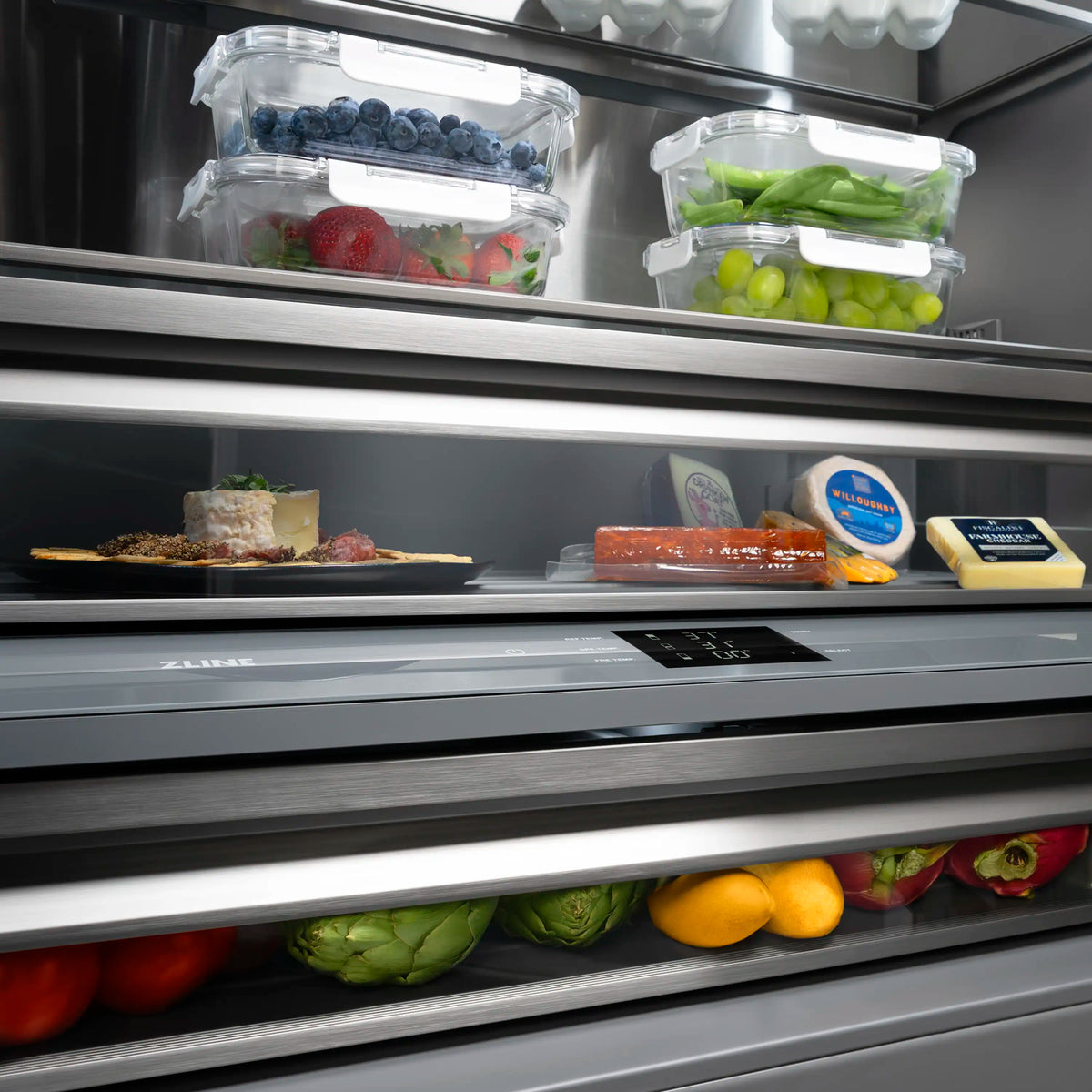 Built-in refrigerator shelf with clear containers of food and graphite gray drawer fronts.