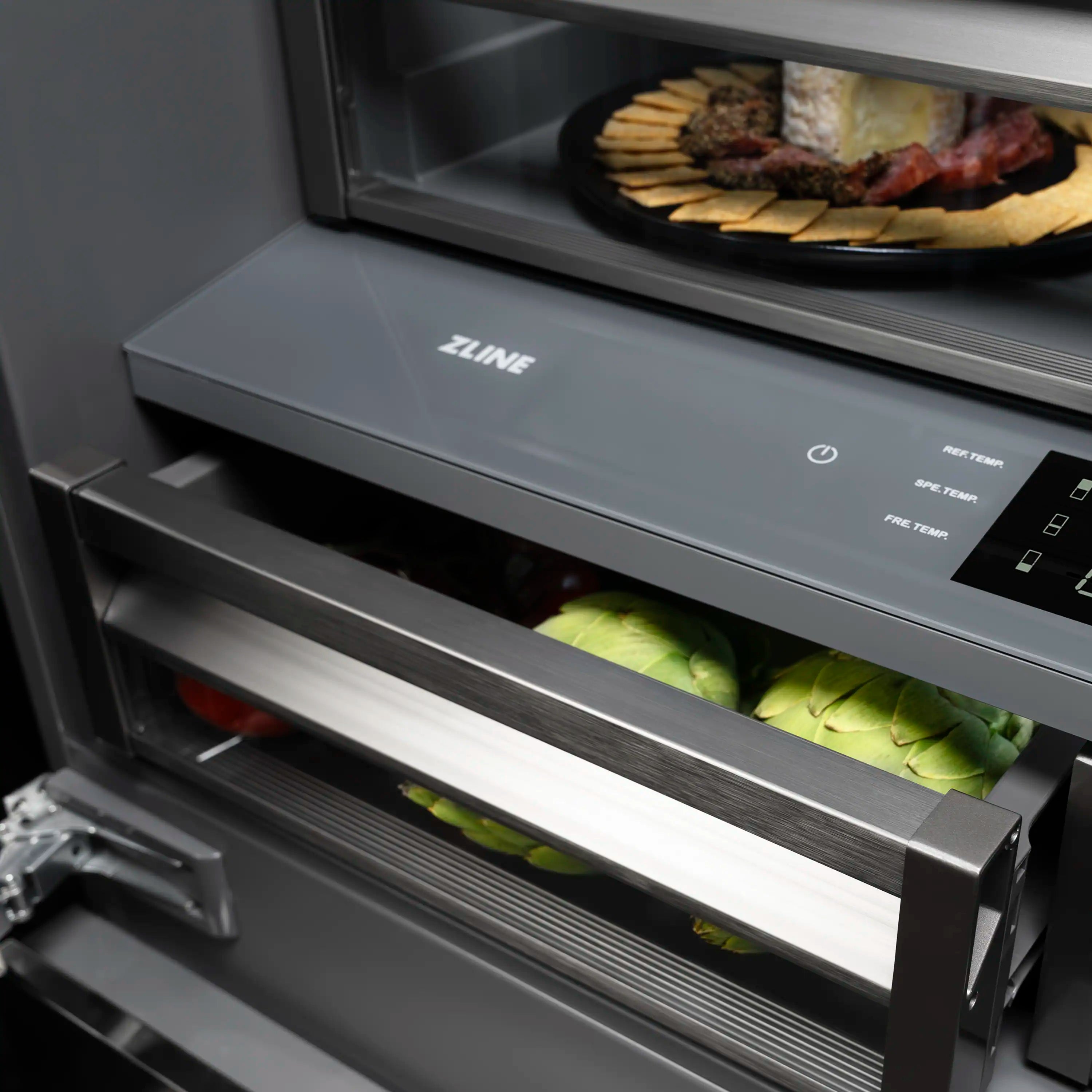 French door refrigerator drawer and digital controls, with green produce inside