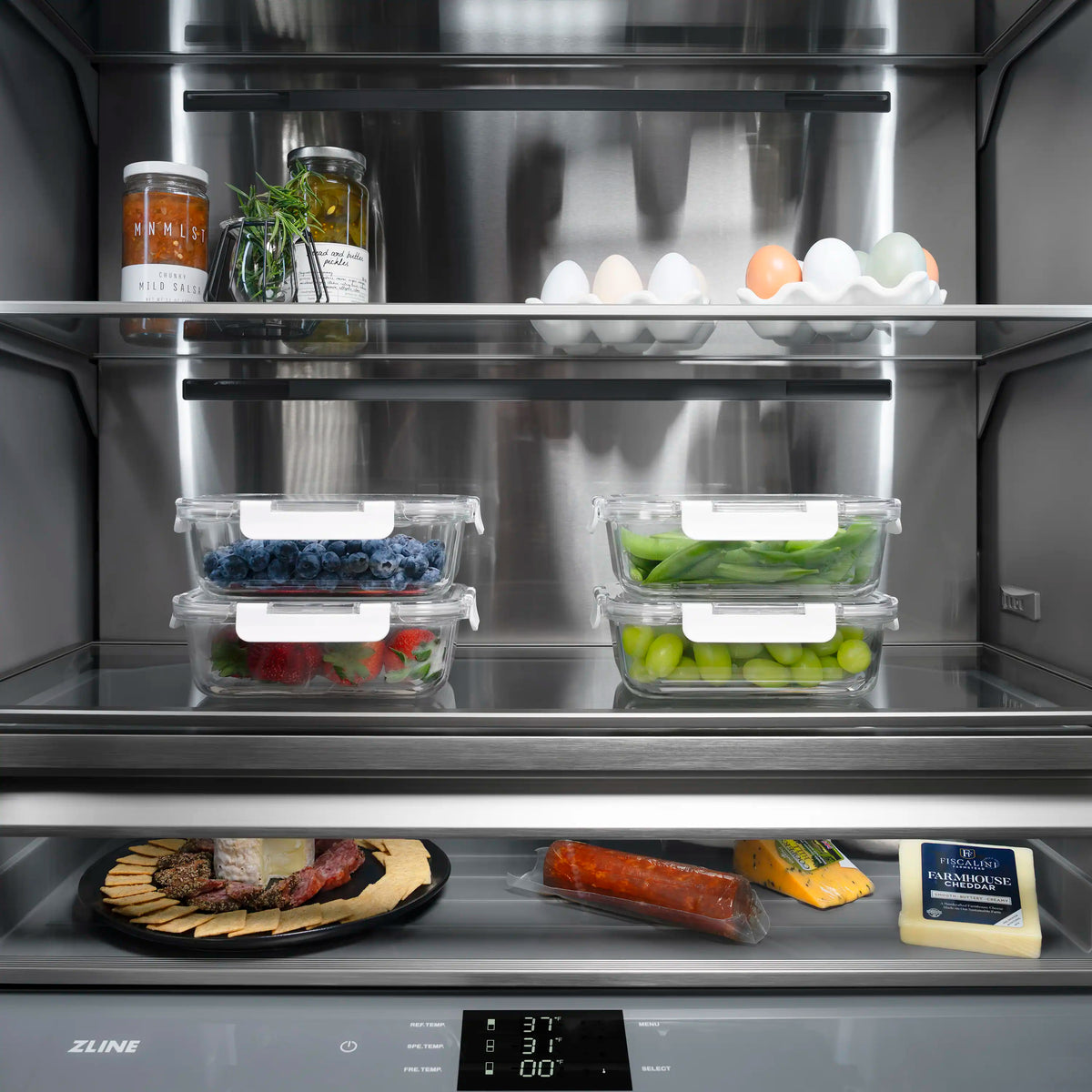 Open refrigerator with gray interior, clear bins, eggs tray, and deli items