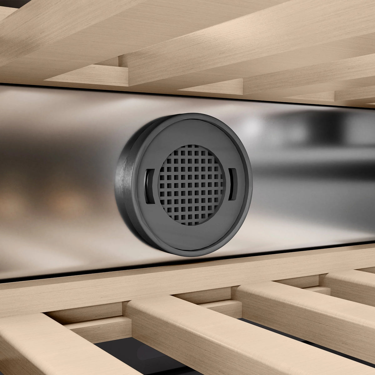 Wine cooler air vent with circular grille and dark trim surround