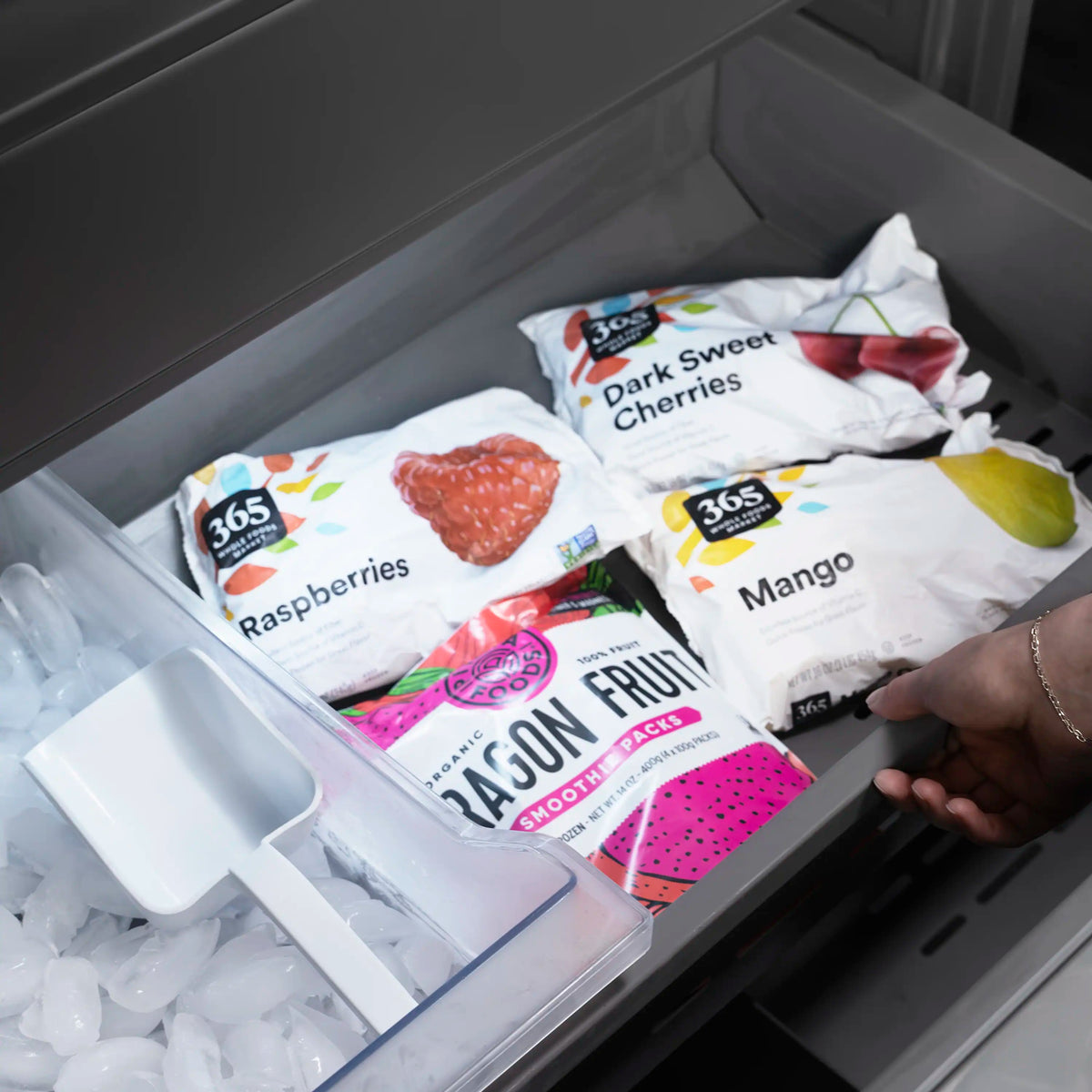 Freezer drawer with packaged food items and ice-ready storage bin