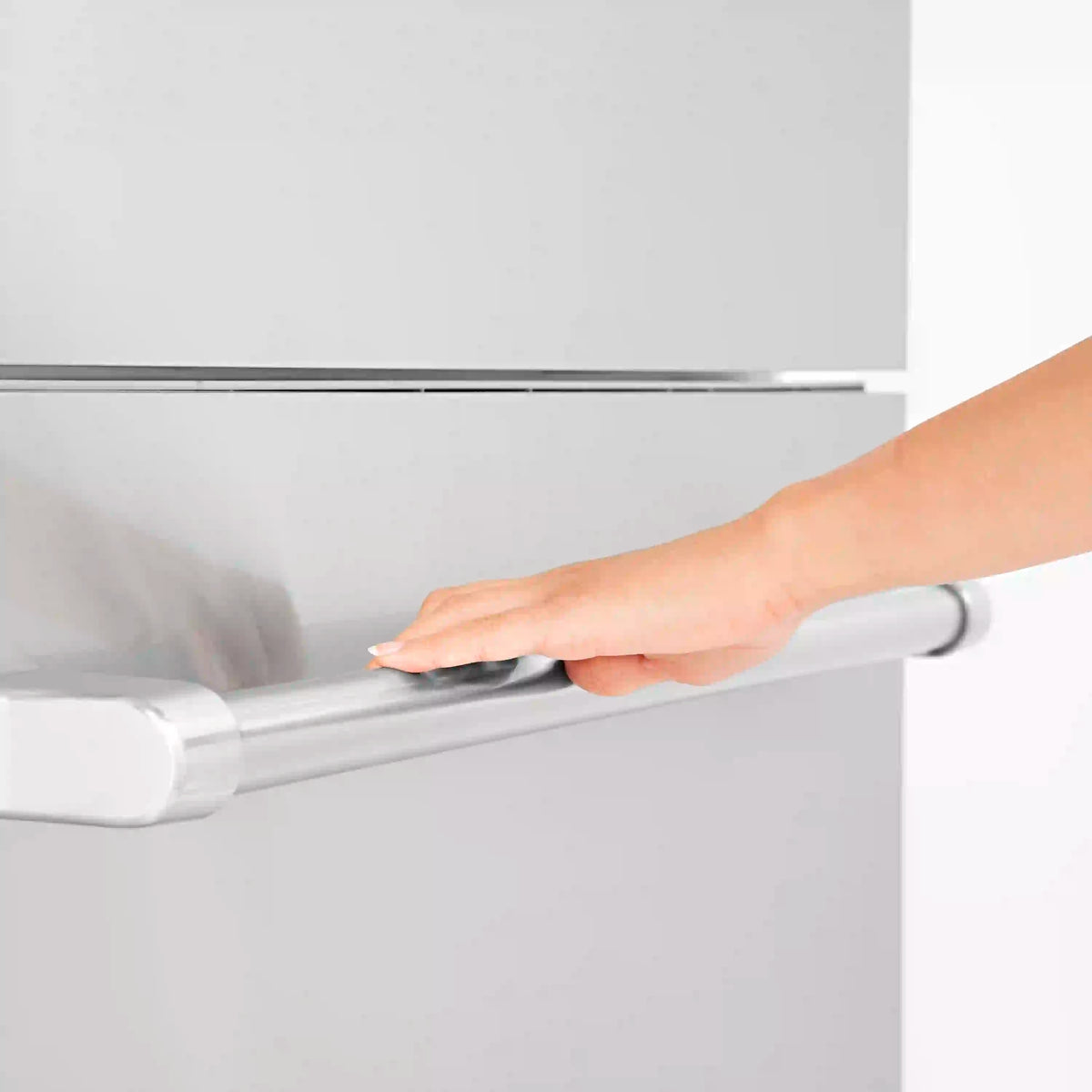 Refrigerator internal dispenser spout with hand reaching to dispense