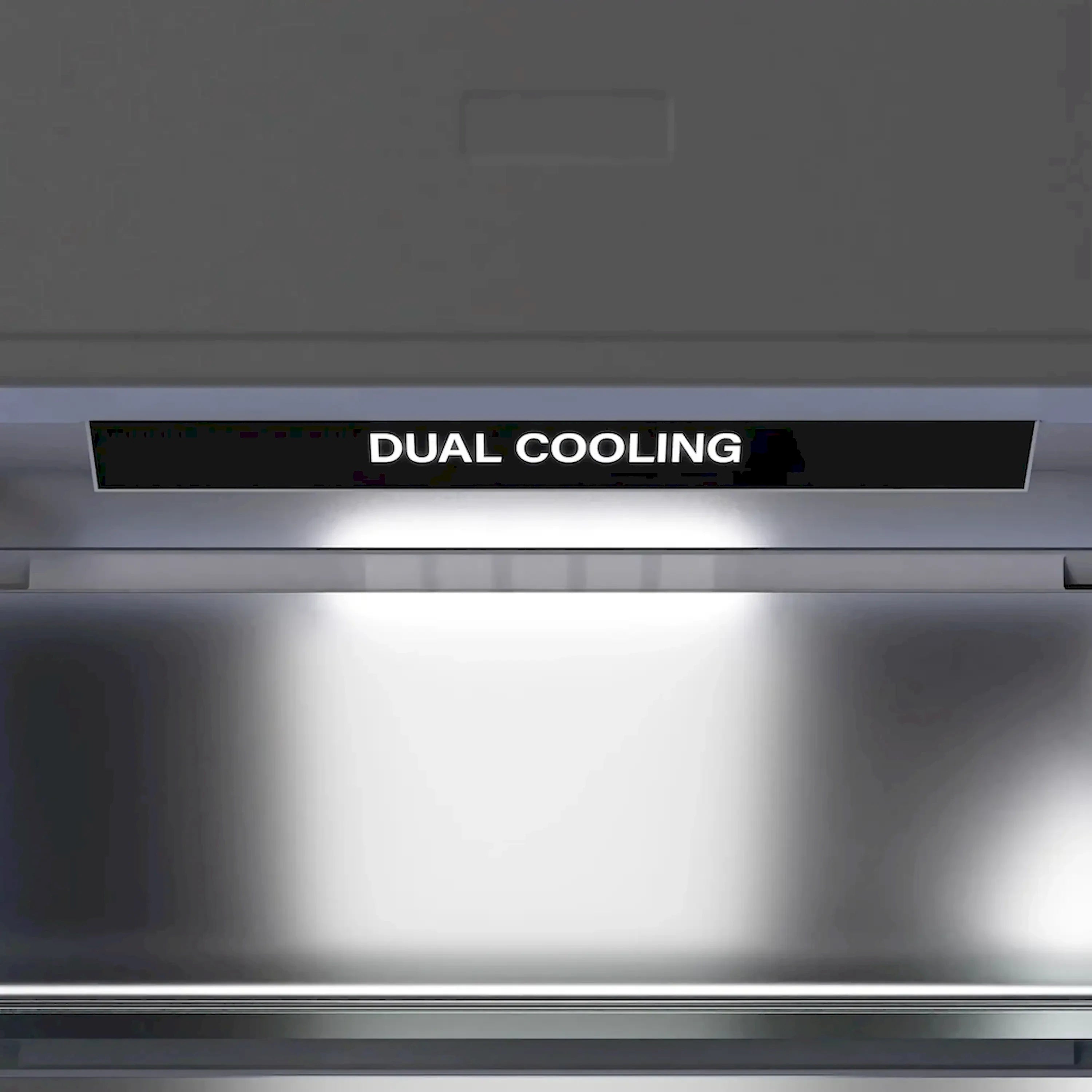 Refrigerator top control area with vent opening and dark dual-cooling label