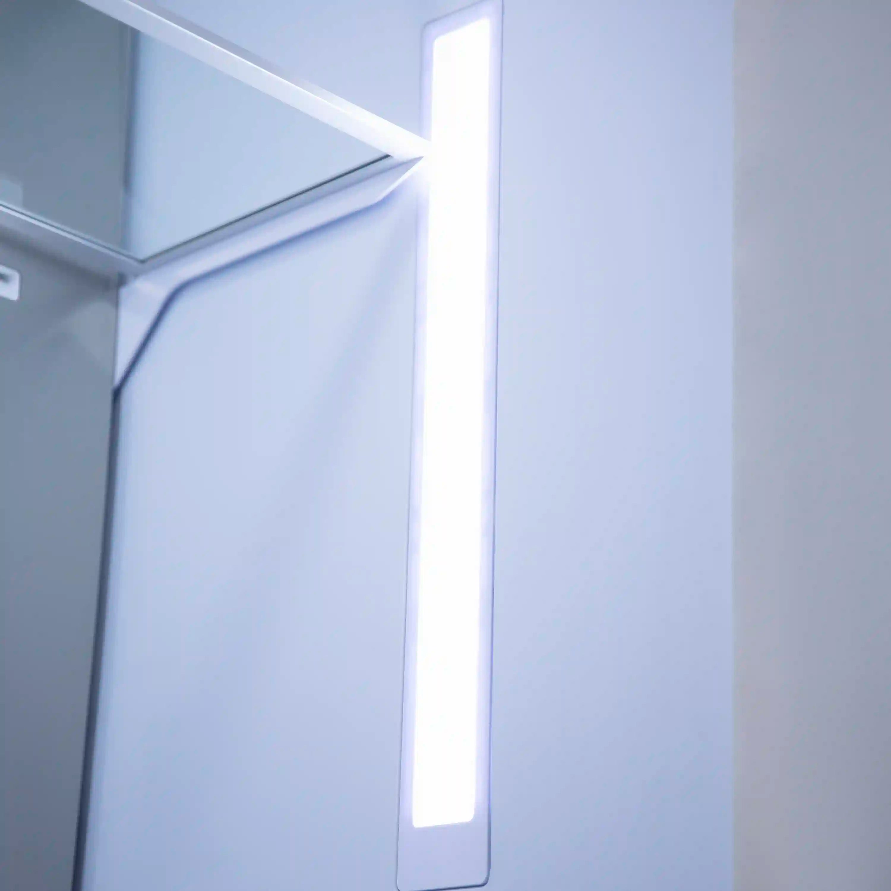 Lit freezer compartment with interior shelves and white door frame