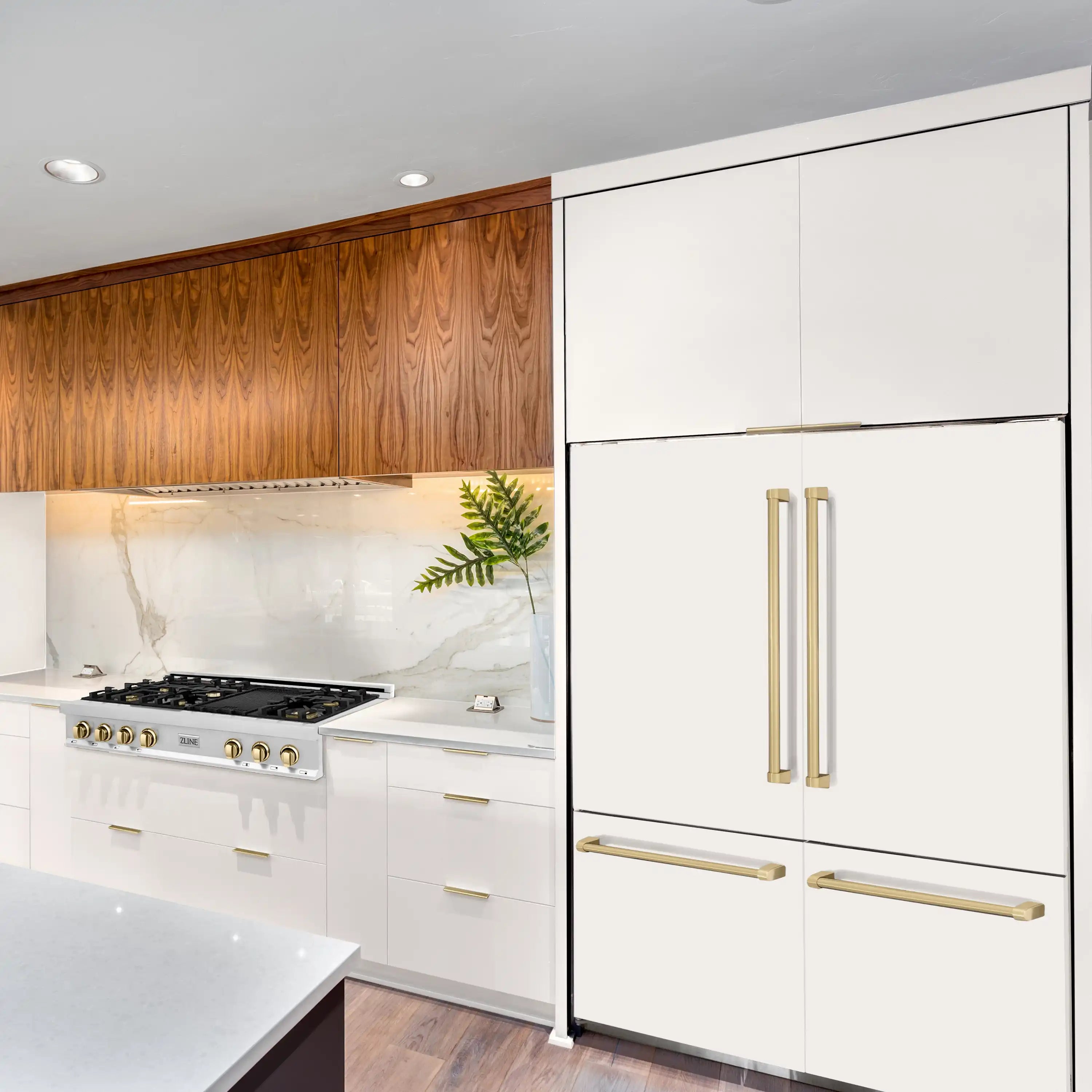 Built-in white French door refrigerator with champagne bronze handles, installed in kitchen