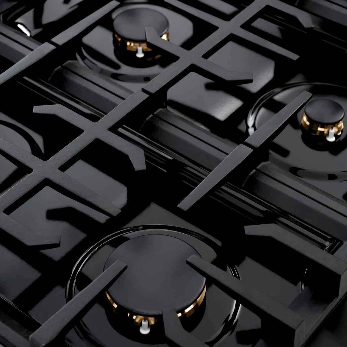 Gas range cooktop with black grates and brass-colored burners