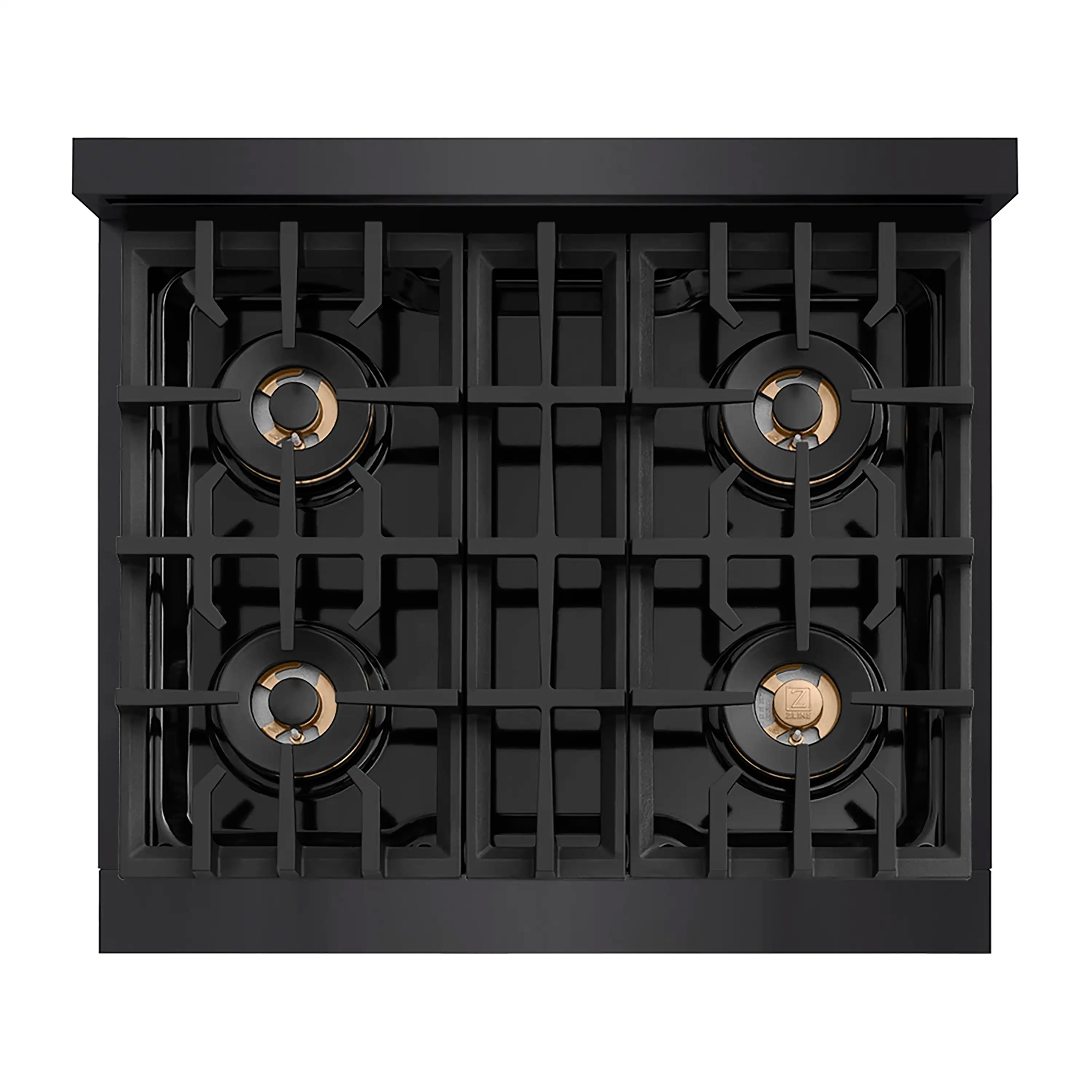 Top view of black 4-burner gas cooktop with brass burner caps in grates