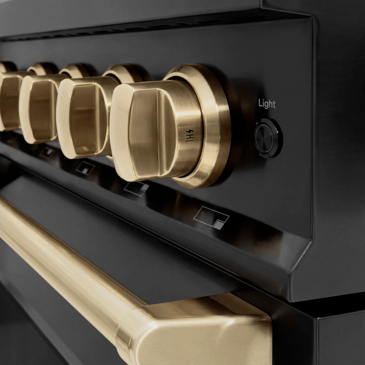Champagne control knob and oven light switch on black range panel