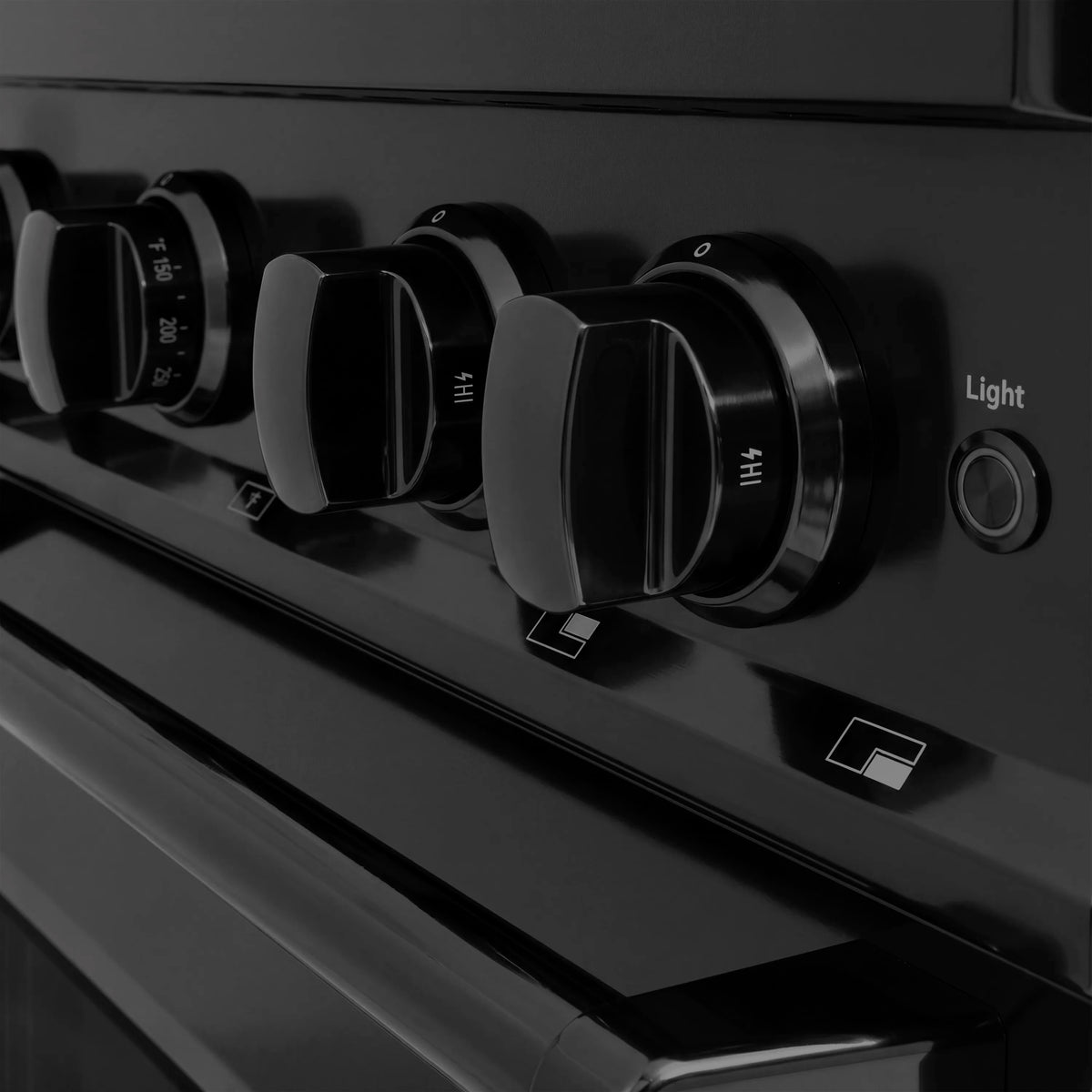 Black gas range control panel with four burner knobs and Light button
