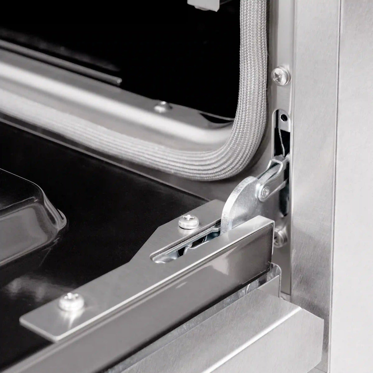 Stainless oven door hinge and mounting bracket detail