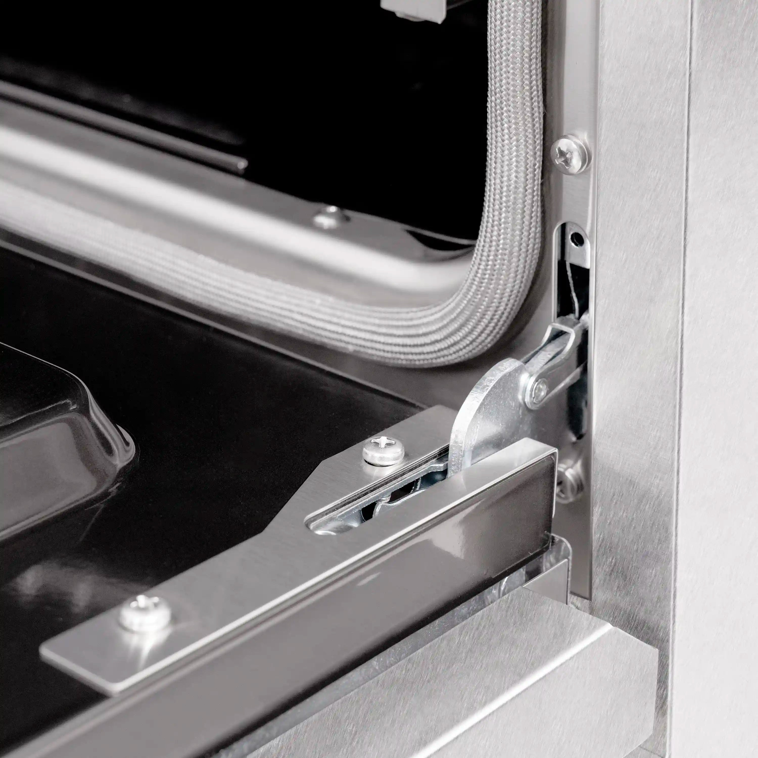 Oven door hinge and metal handle mechanism on stainless steel range