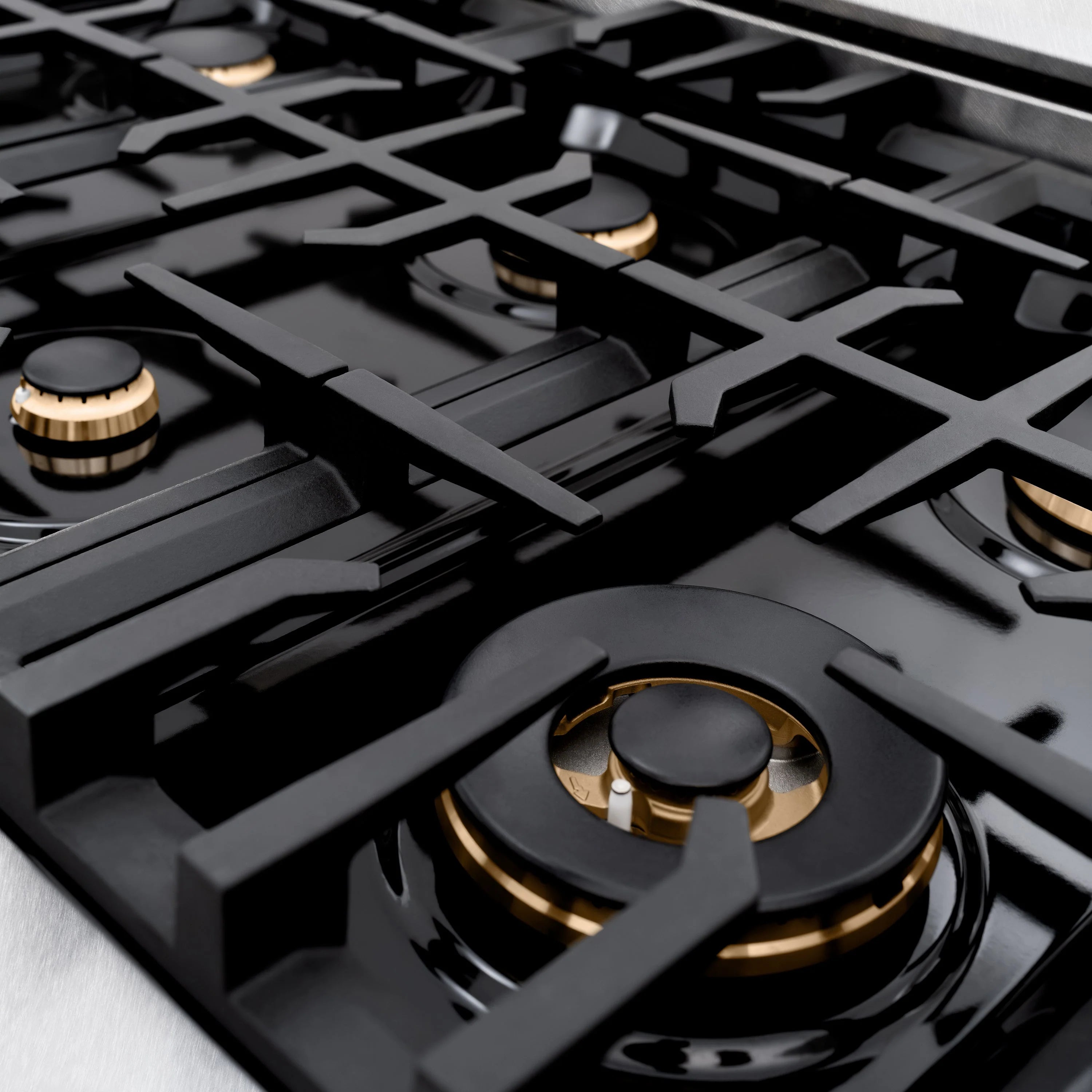 Gas burner with black grate and brass-trim flame ring
