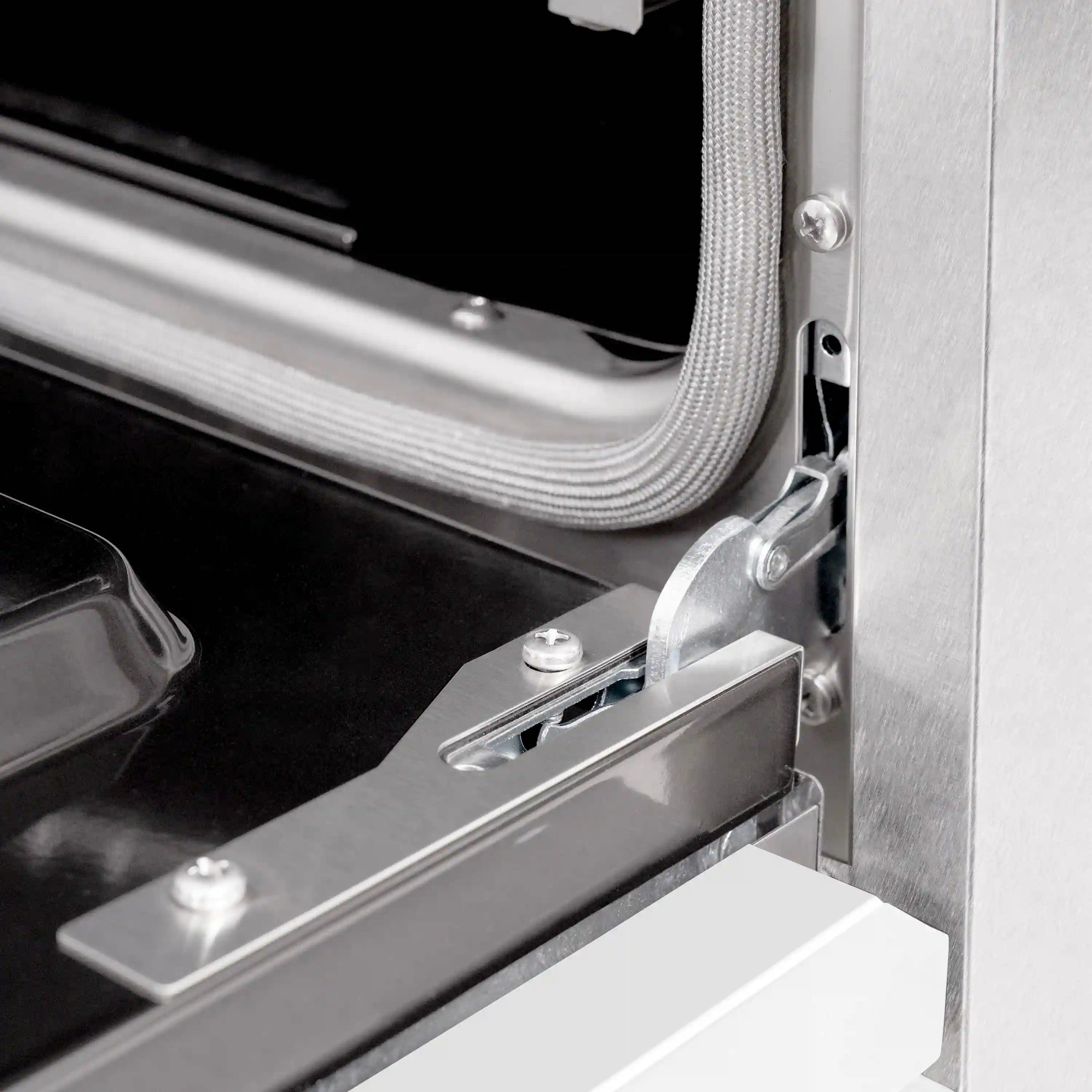 Gas oven door hinge and latch hardware on satin stainless steel range