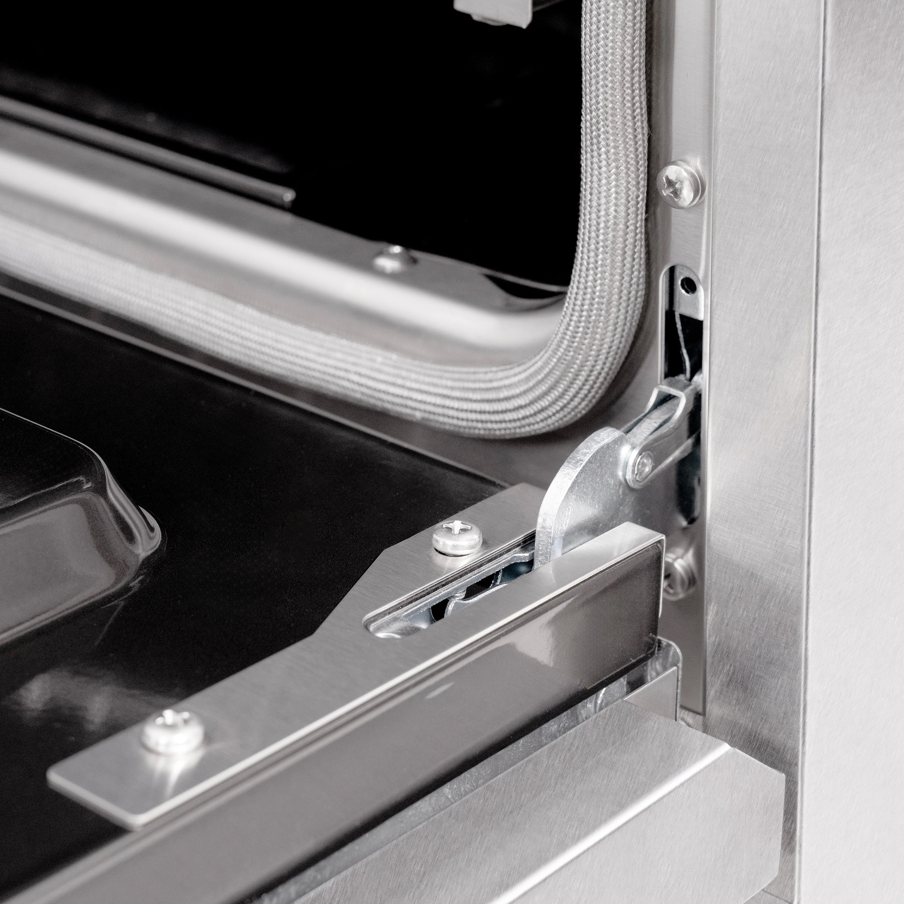 Stainless oven door hinge and latch mechanism with mounting screws and metal handle