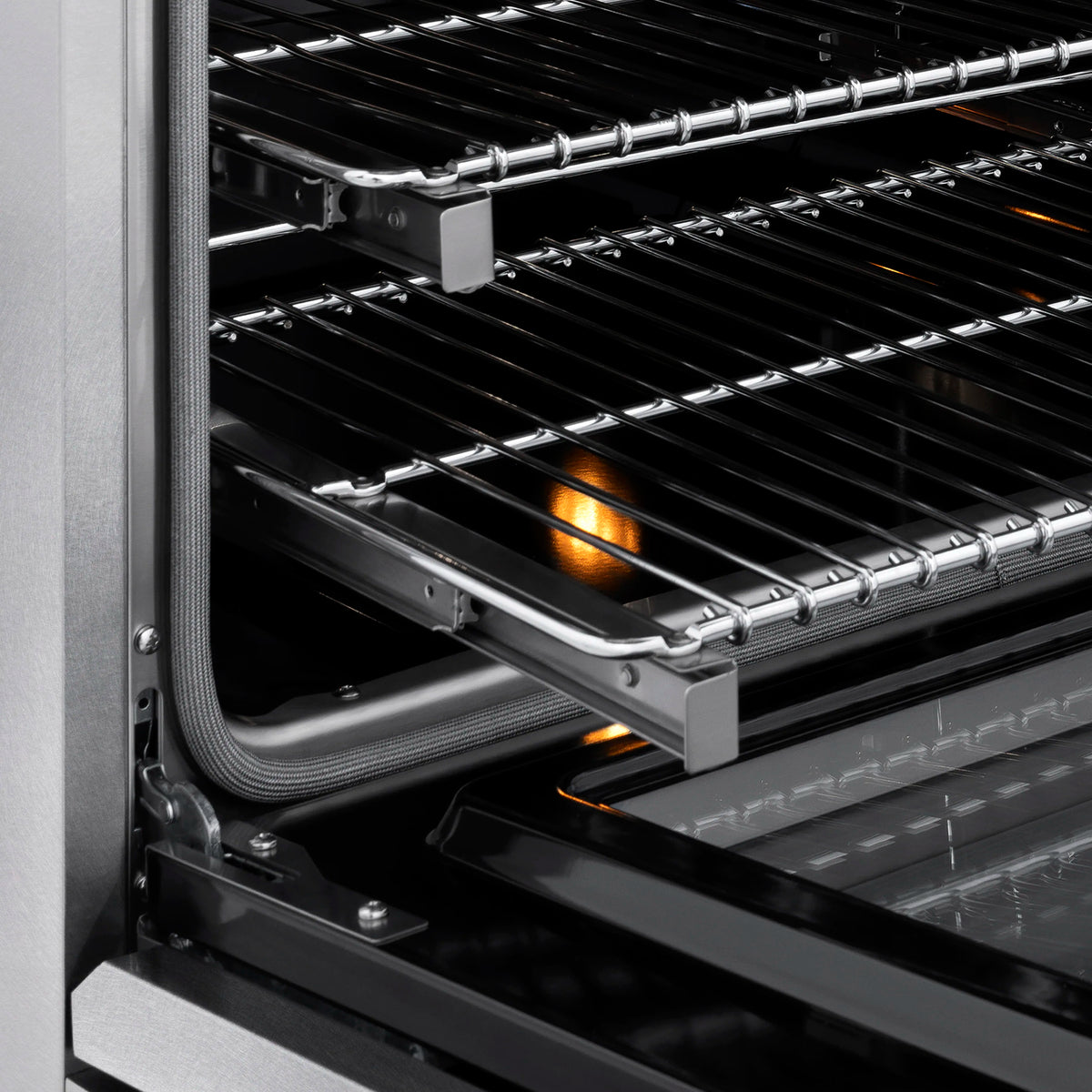 Convection oven interior with broil rack and glowing heating element