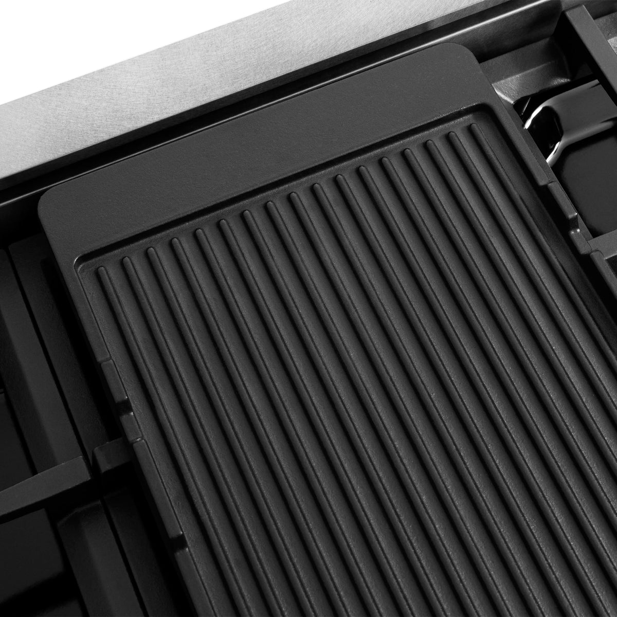 Black ribbed cooktop insert with raised ridges and surrounding grates