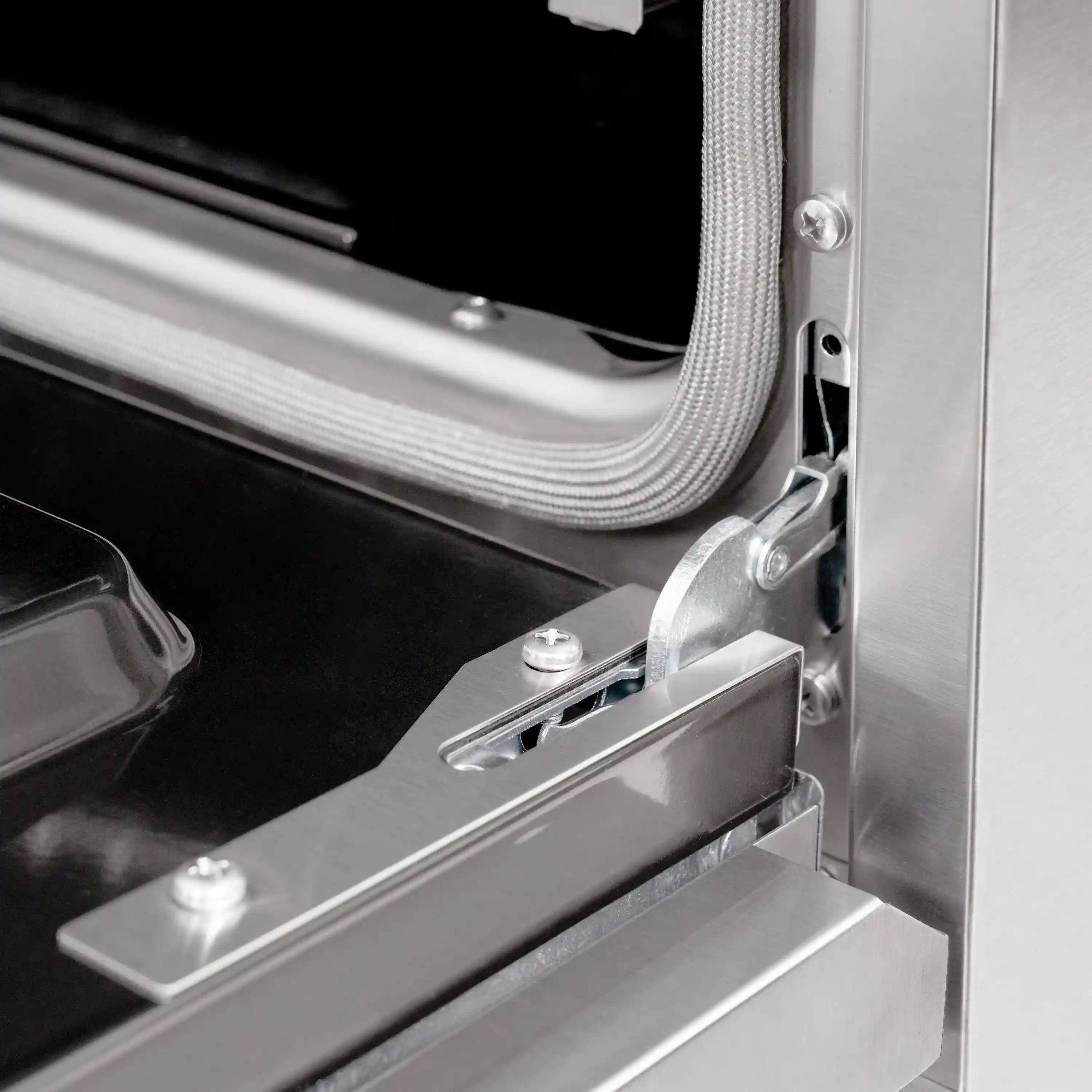 Dual fuel range oven door hinge and latch hardware on stainless steel frame