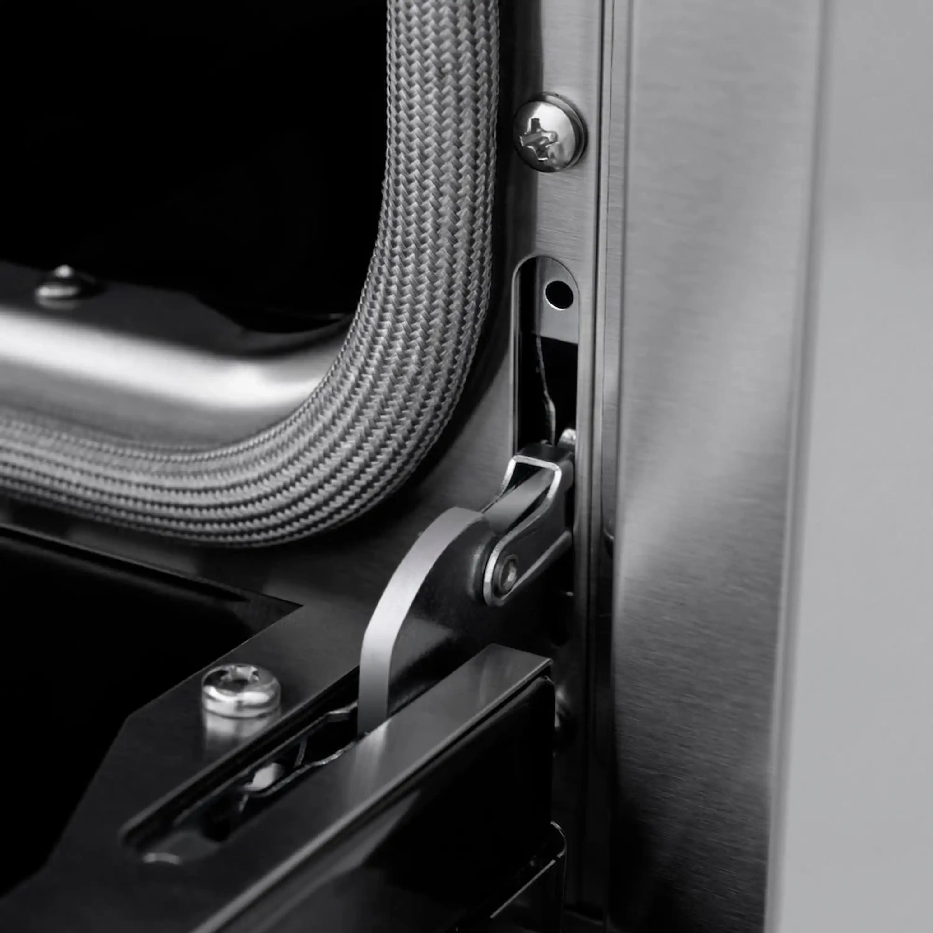 Stainless steel range side with black gas hose connector and metal control latch