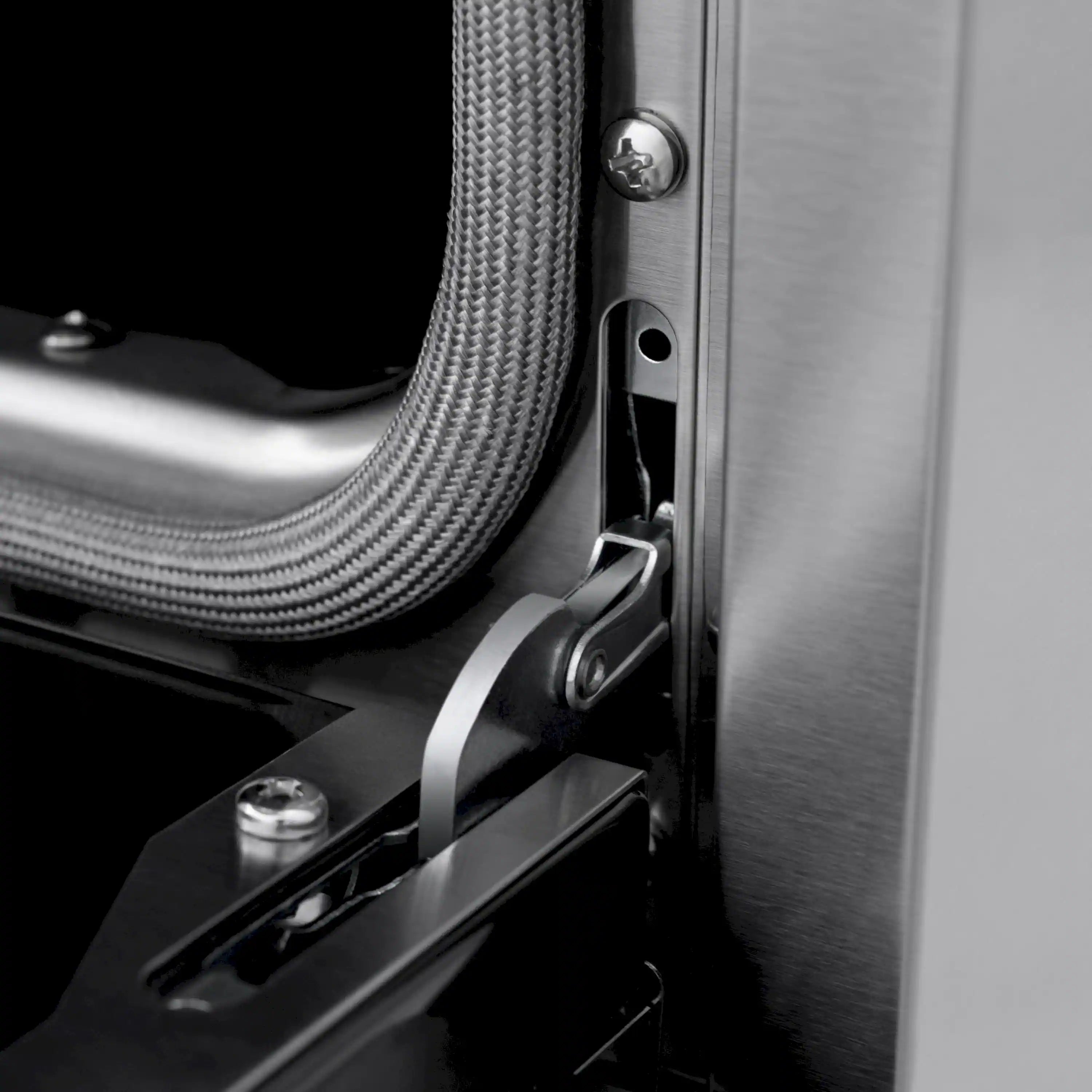 Close-up of range side vent area with gas hose connection and metal latch