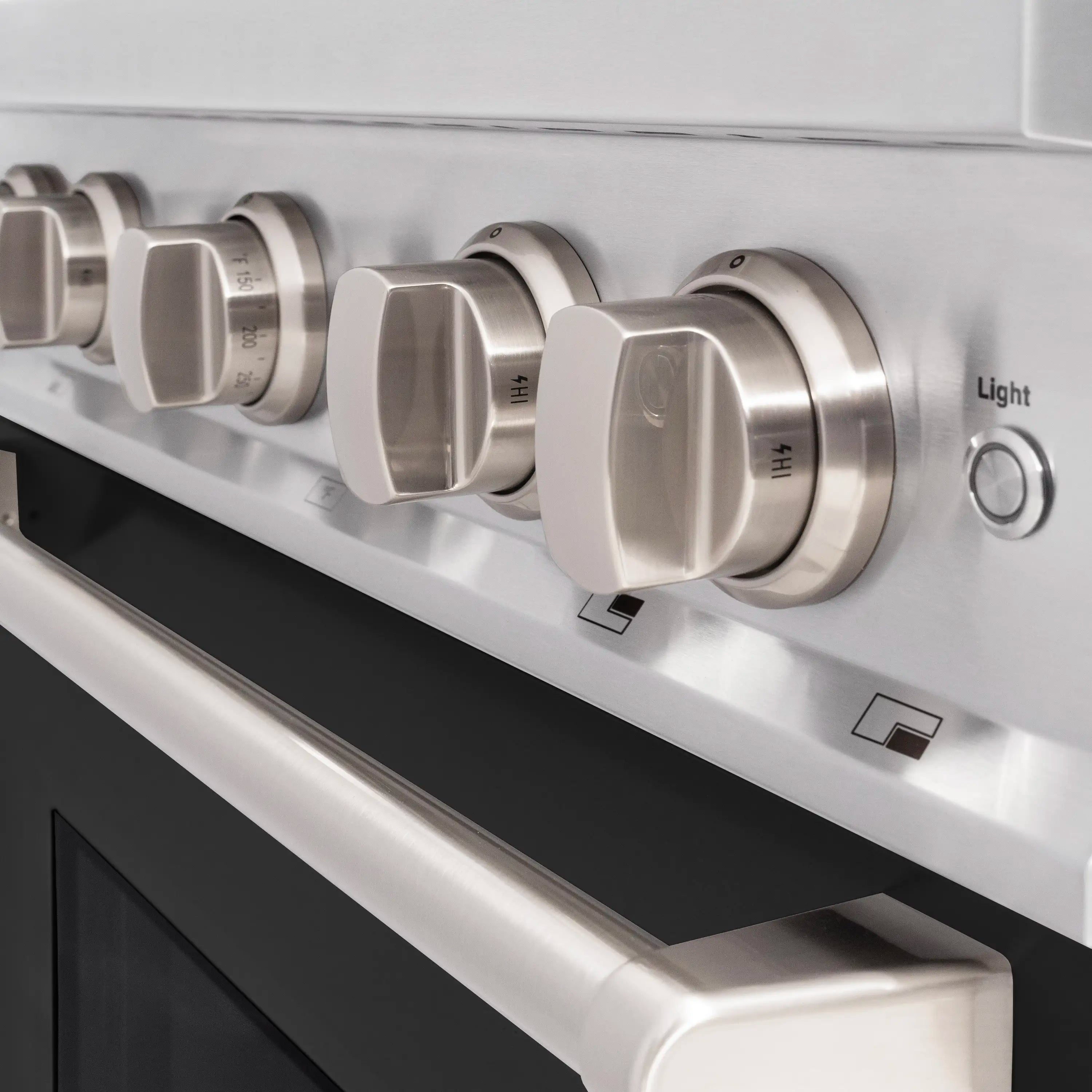 Stainless steel control panel with round burner knobs and a 'Light' button