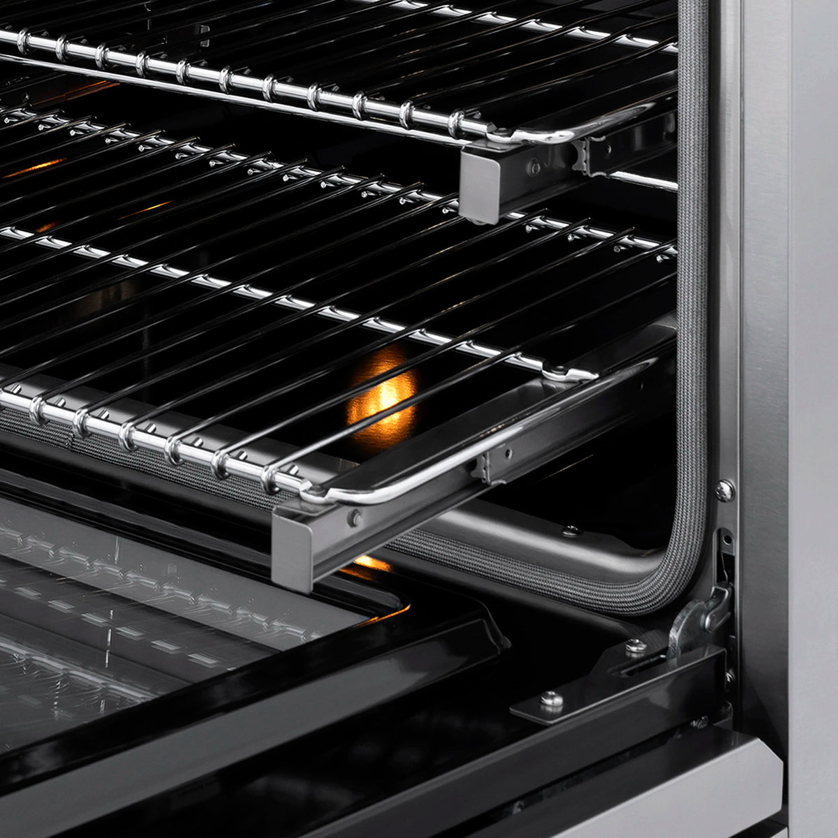 Oven cooking grates with a lit burner glow and open oven door frame