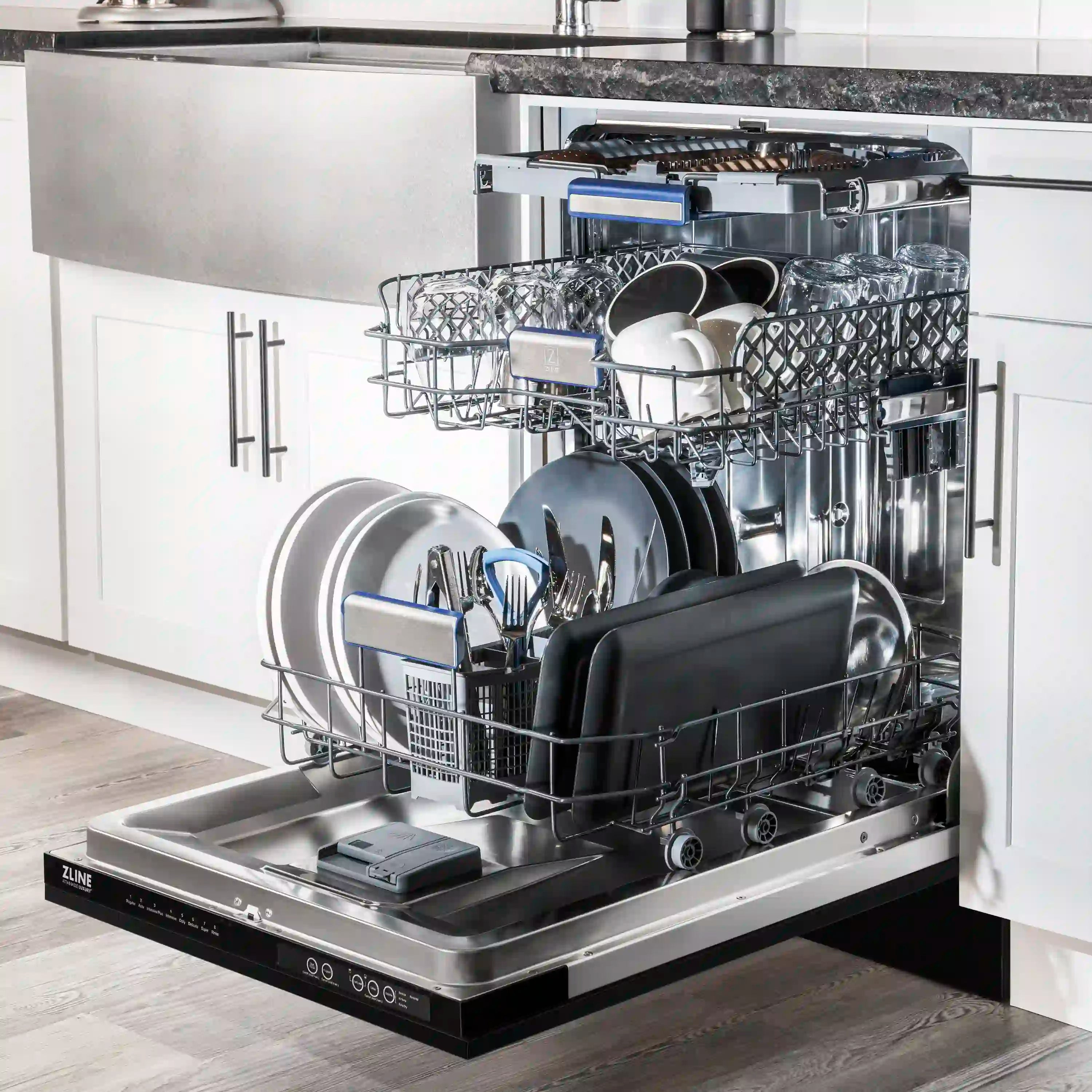 Built-in dishwasher interior with upper and lower racks holding dishware, door open.