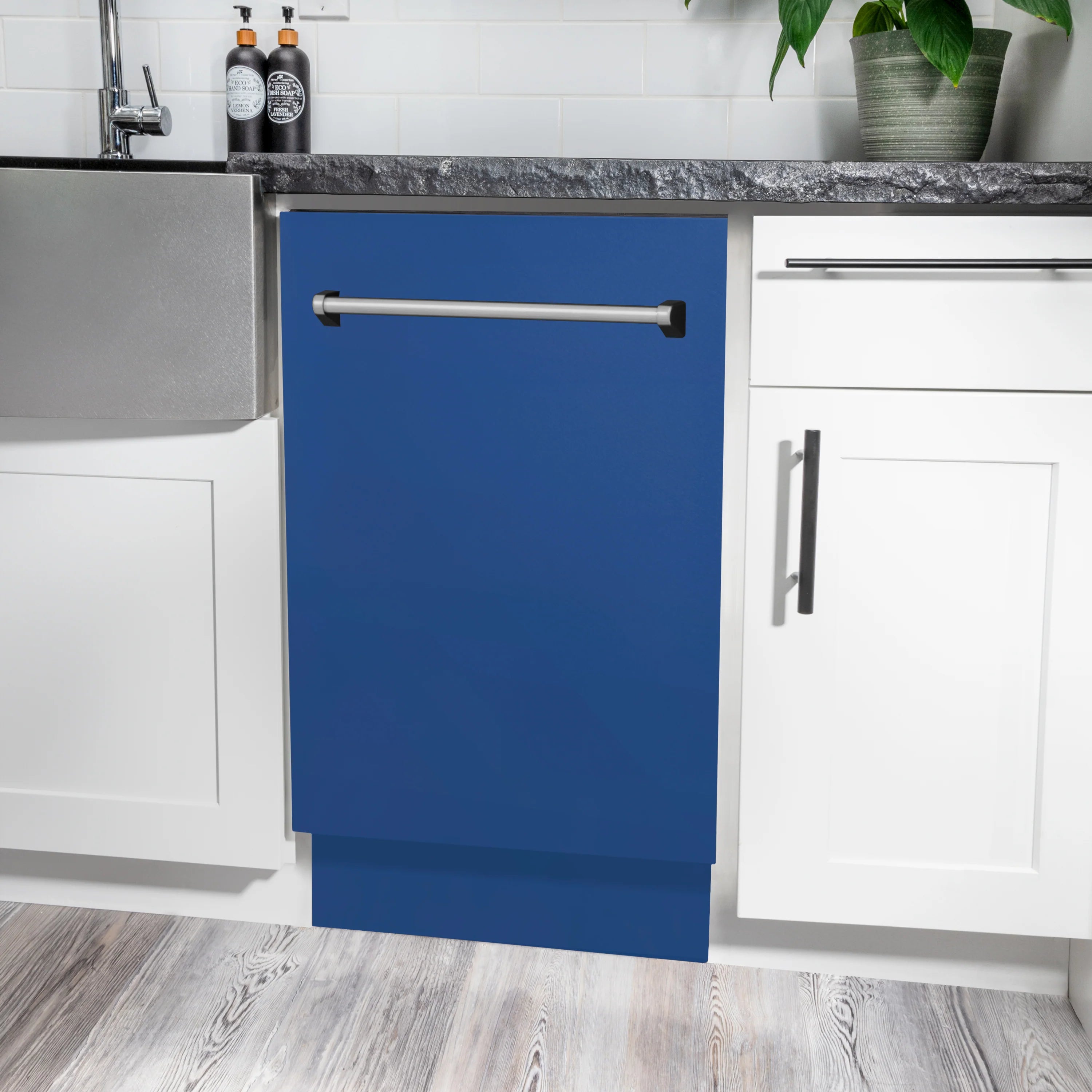 Built-in blue matte dishwasher with stainless handle, installed between cabinets