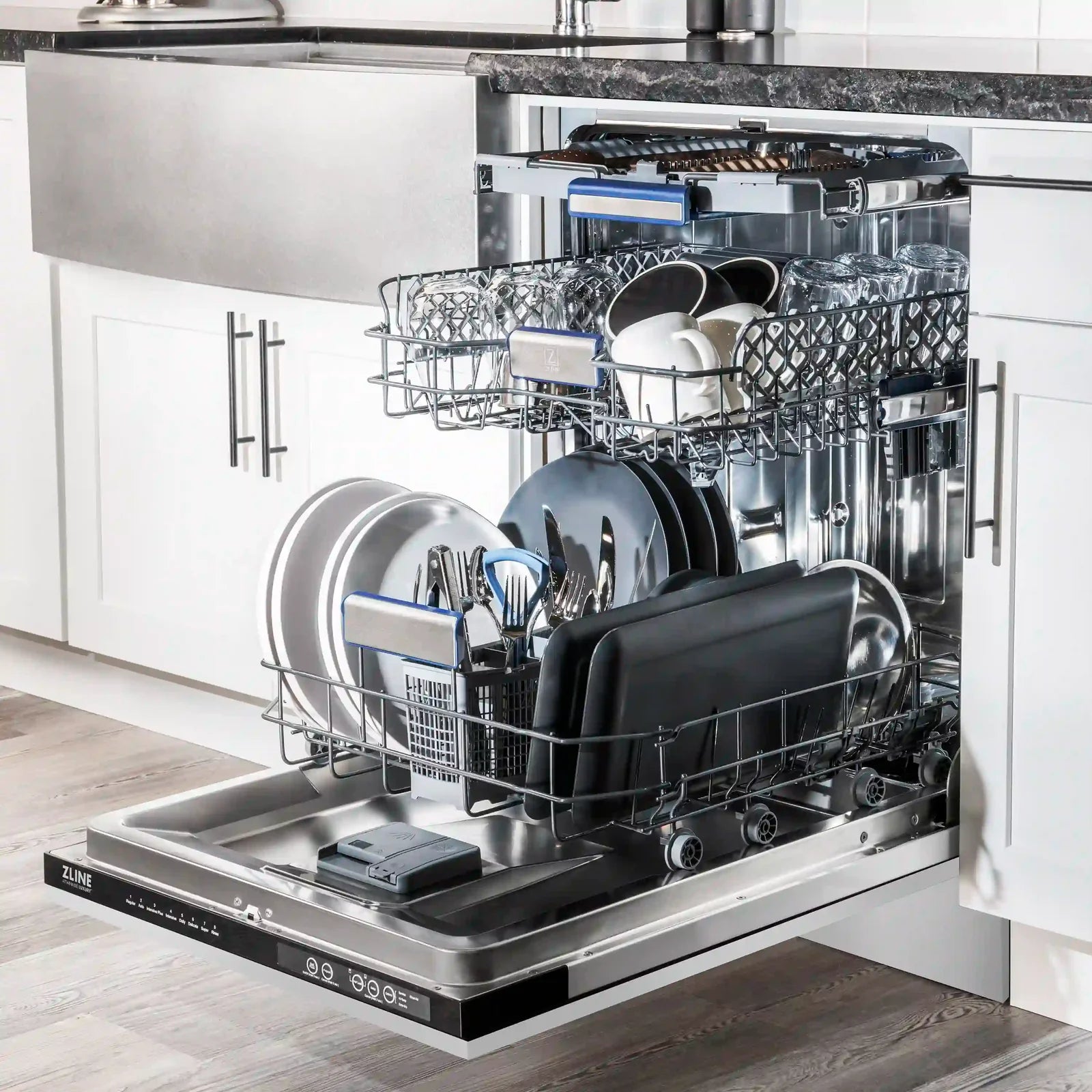 Stainless steel tall tub dishwasher with open door and loaded racks