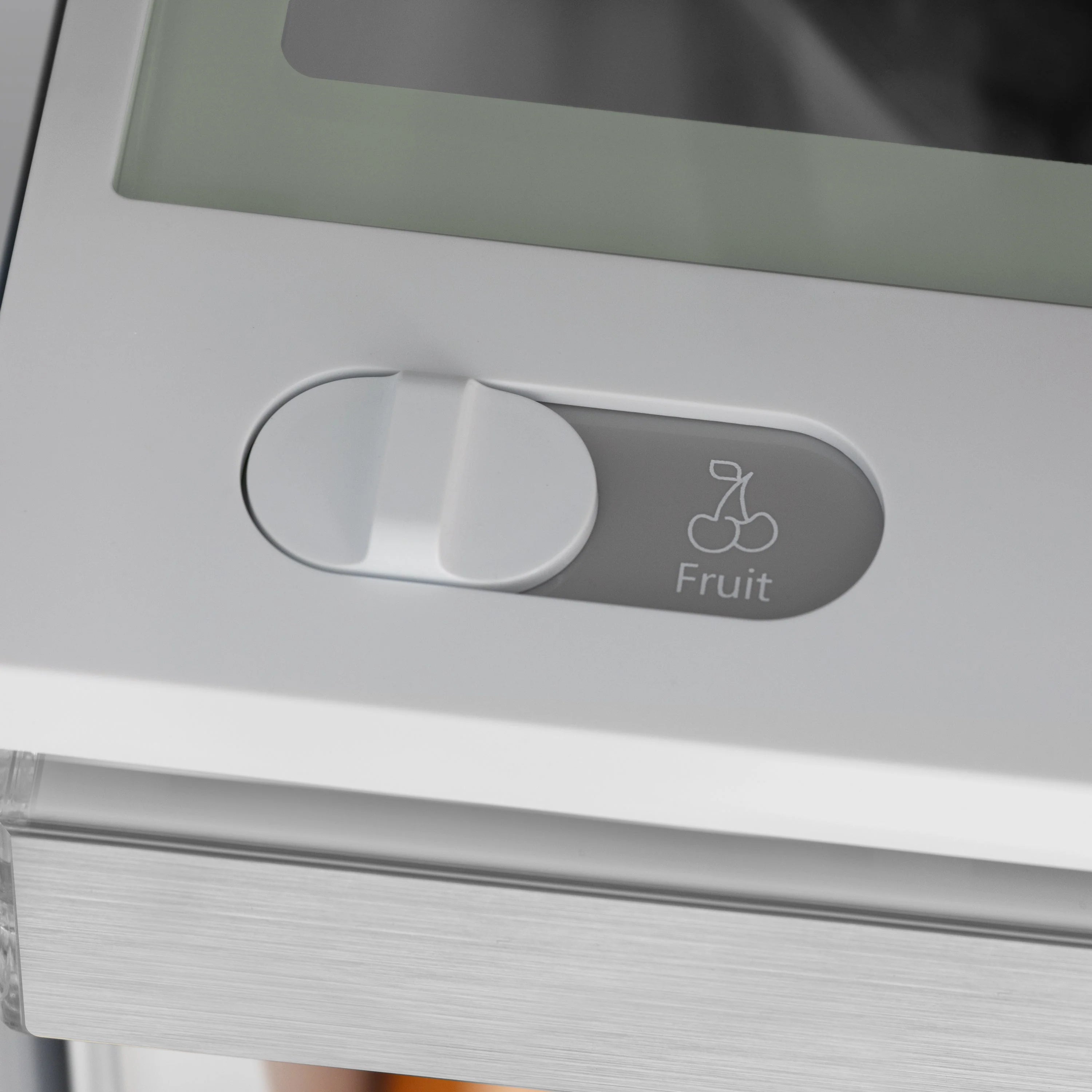 Refrigerator produce drawer labeled for fruit with slide-out cover