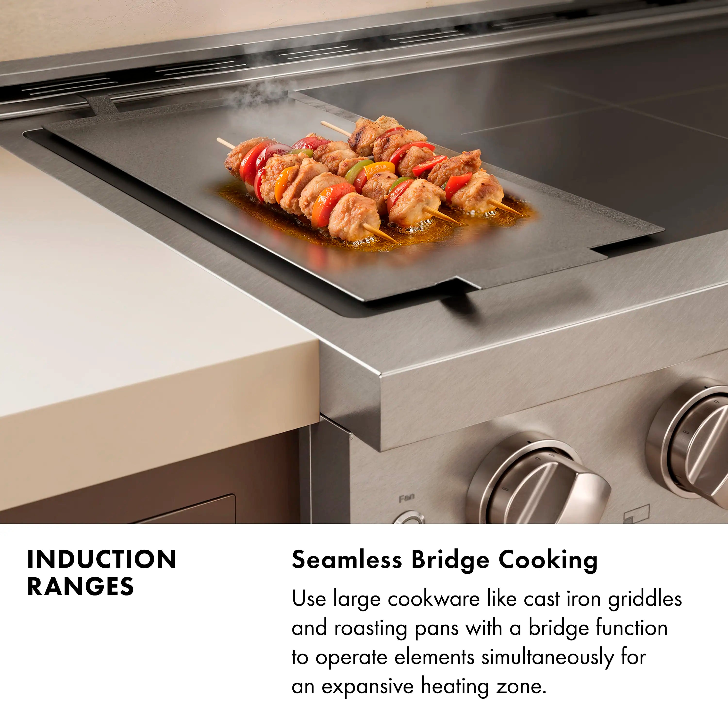 Stainless steel induction range cooktop with four heating zones and food on griddle
