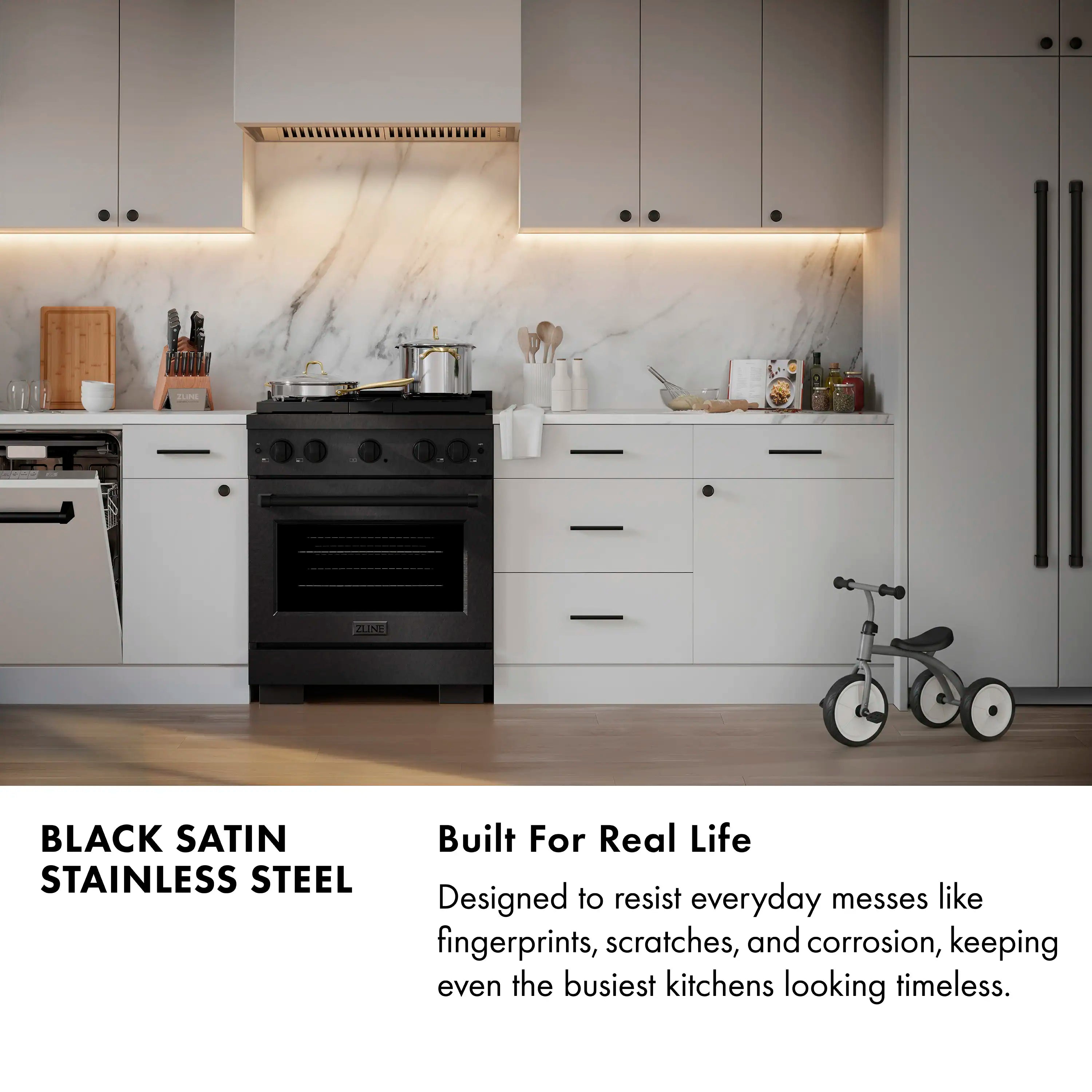 Black gas range with stainless steel oven door and gold control knobs