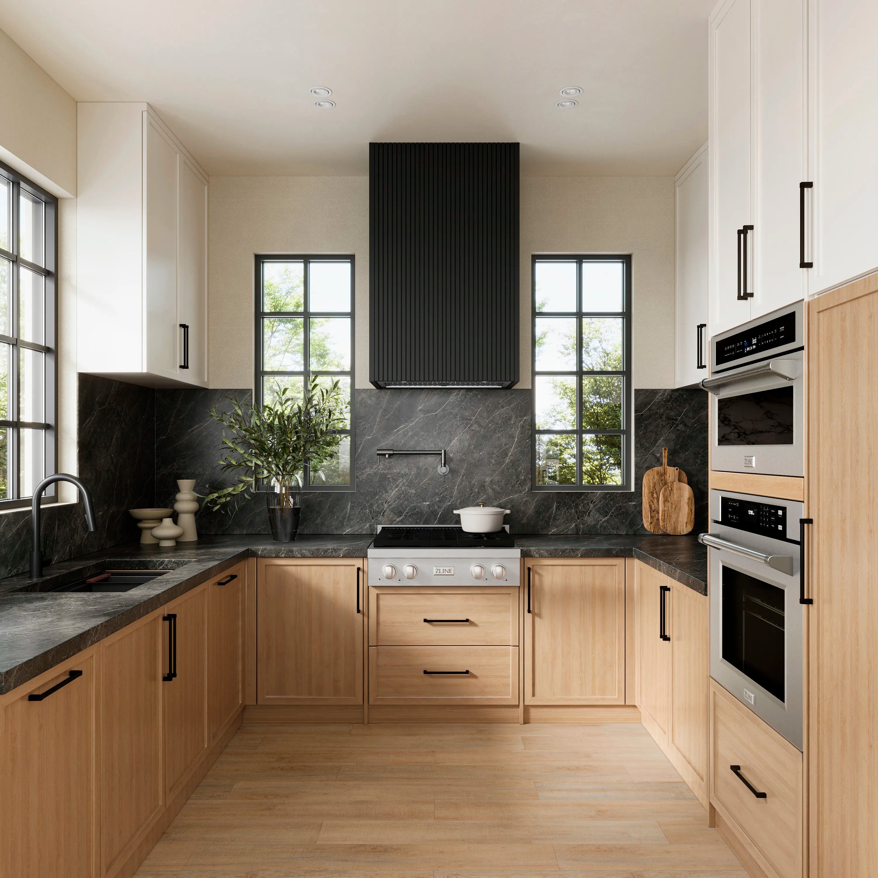 Stainless steel wall-mount range hood insert with black chimney cover, installed over stove