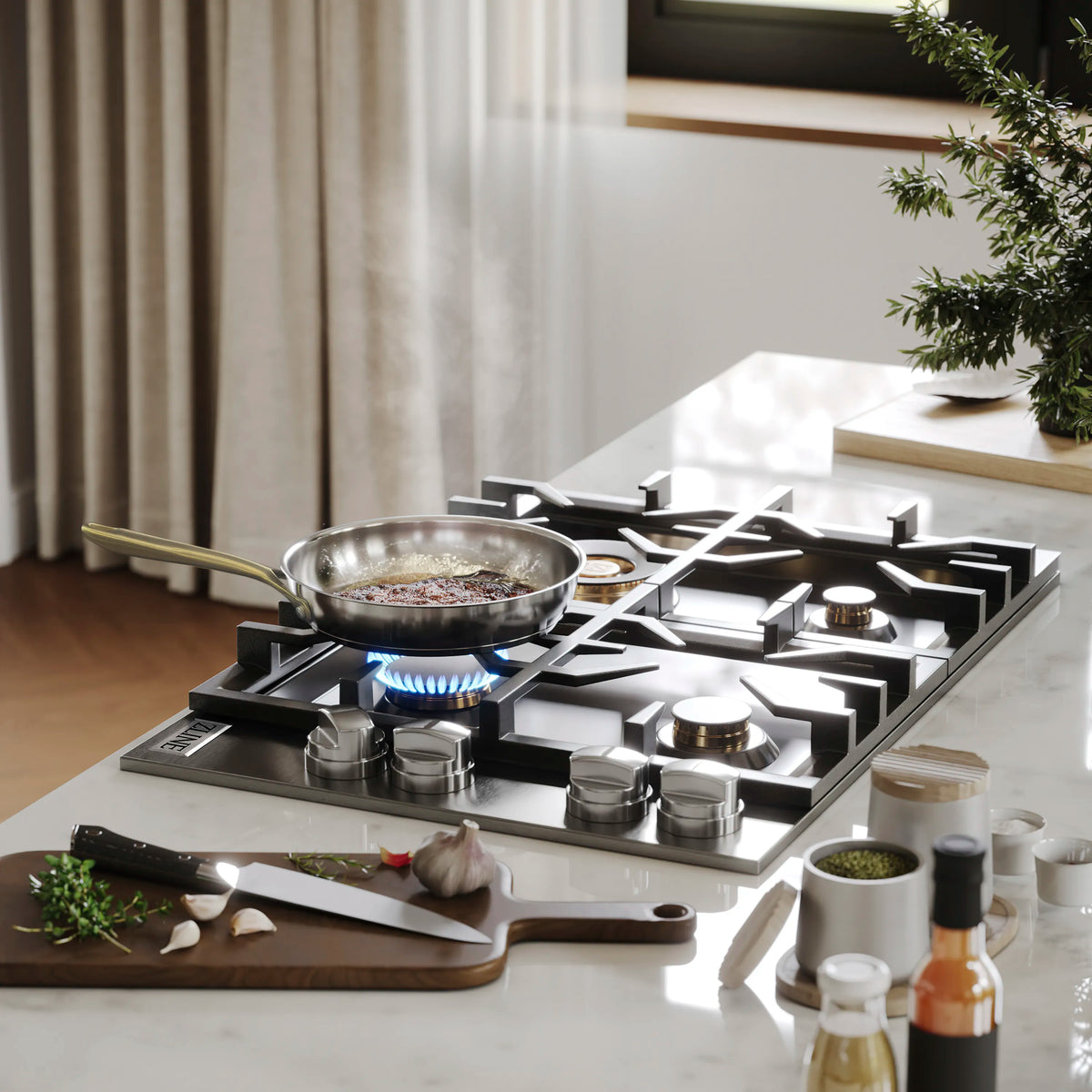 Black four-burner gas cooktop with cast grates, lit blue flame under pan