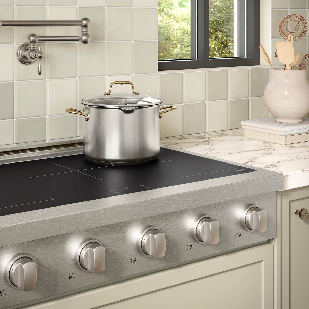 Satin stainless steel induction rangetop with cooktop surface and control knobs