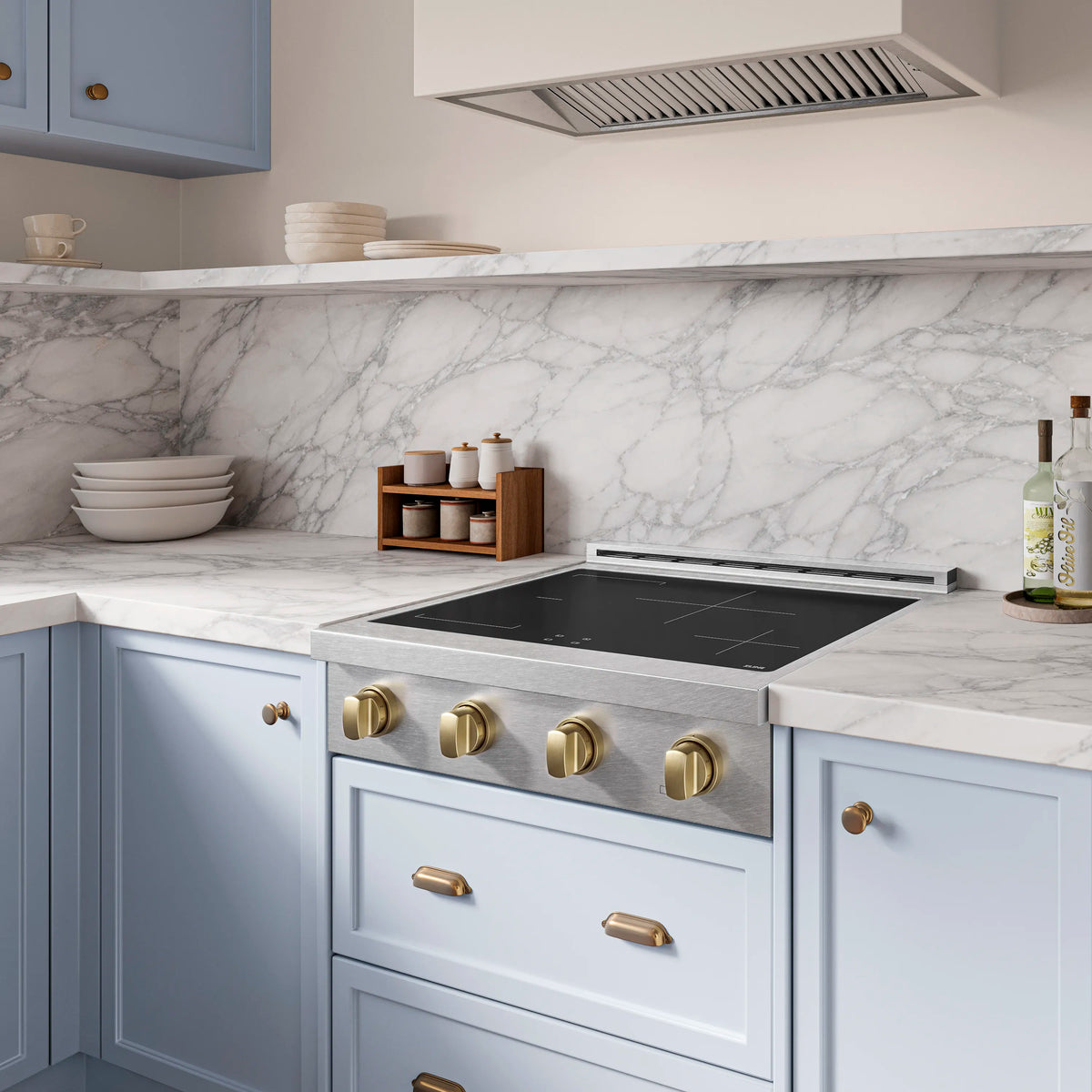 Built-in induction cooktop with black glass top and champagne bronze control knobs