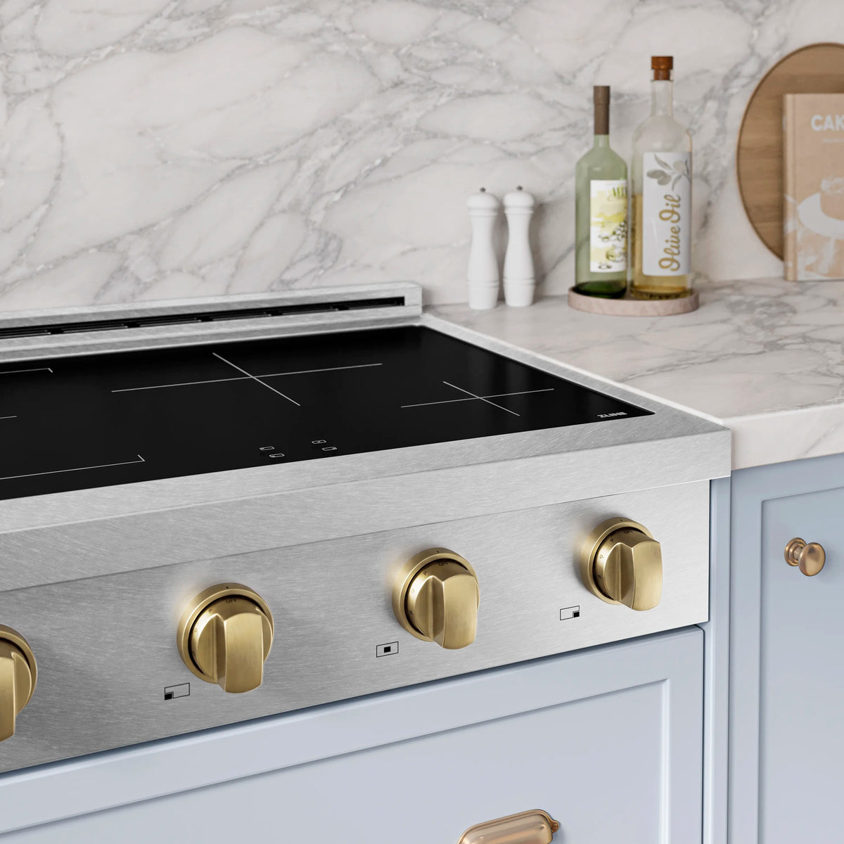Satin stainless steel induction cooktop with champagne bronze knob accents