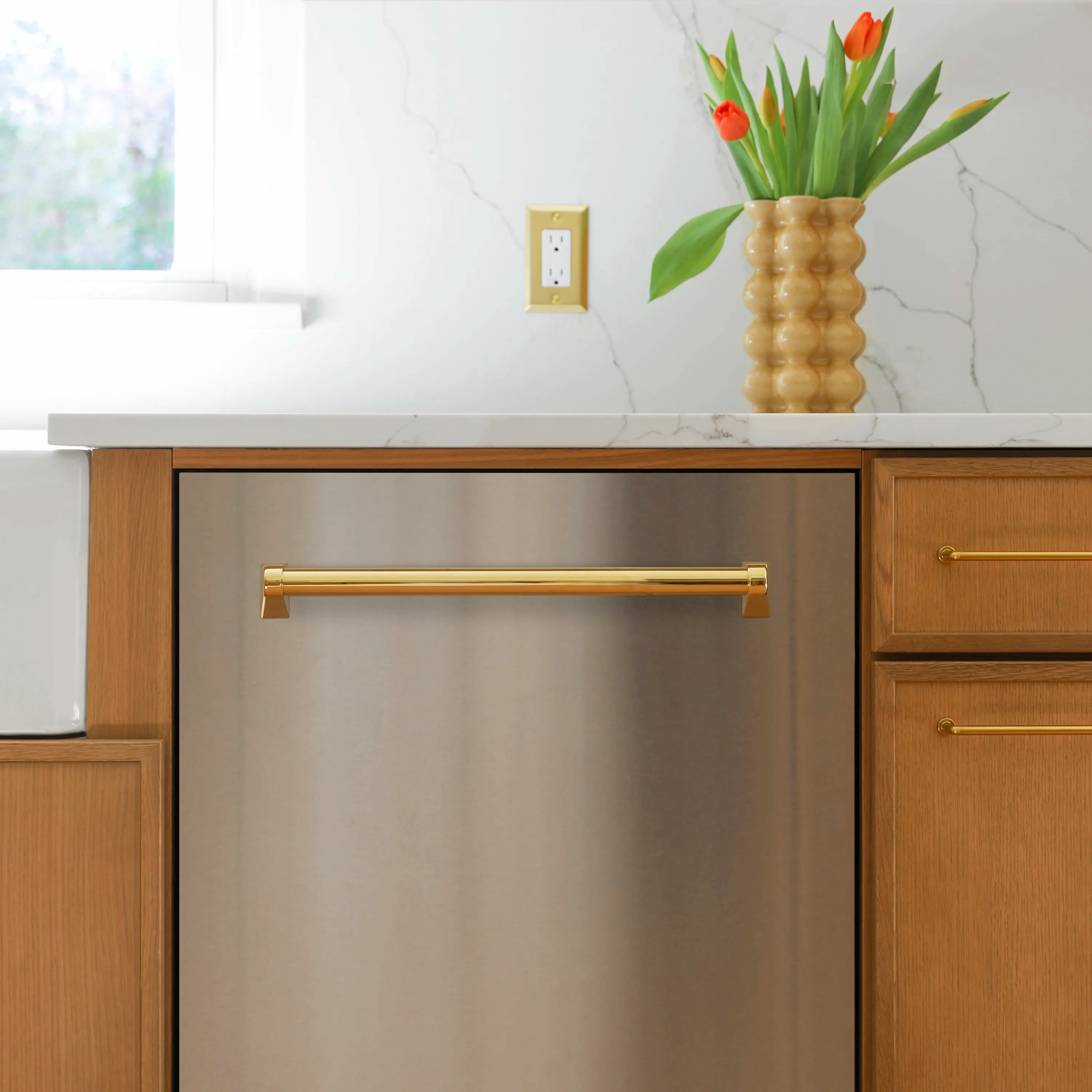 Built-in dishwasher front with gold bar handle in a kitchen cabinet opening