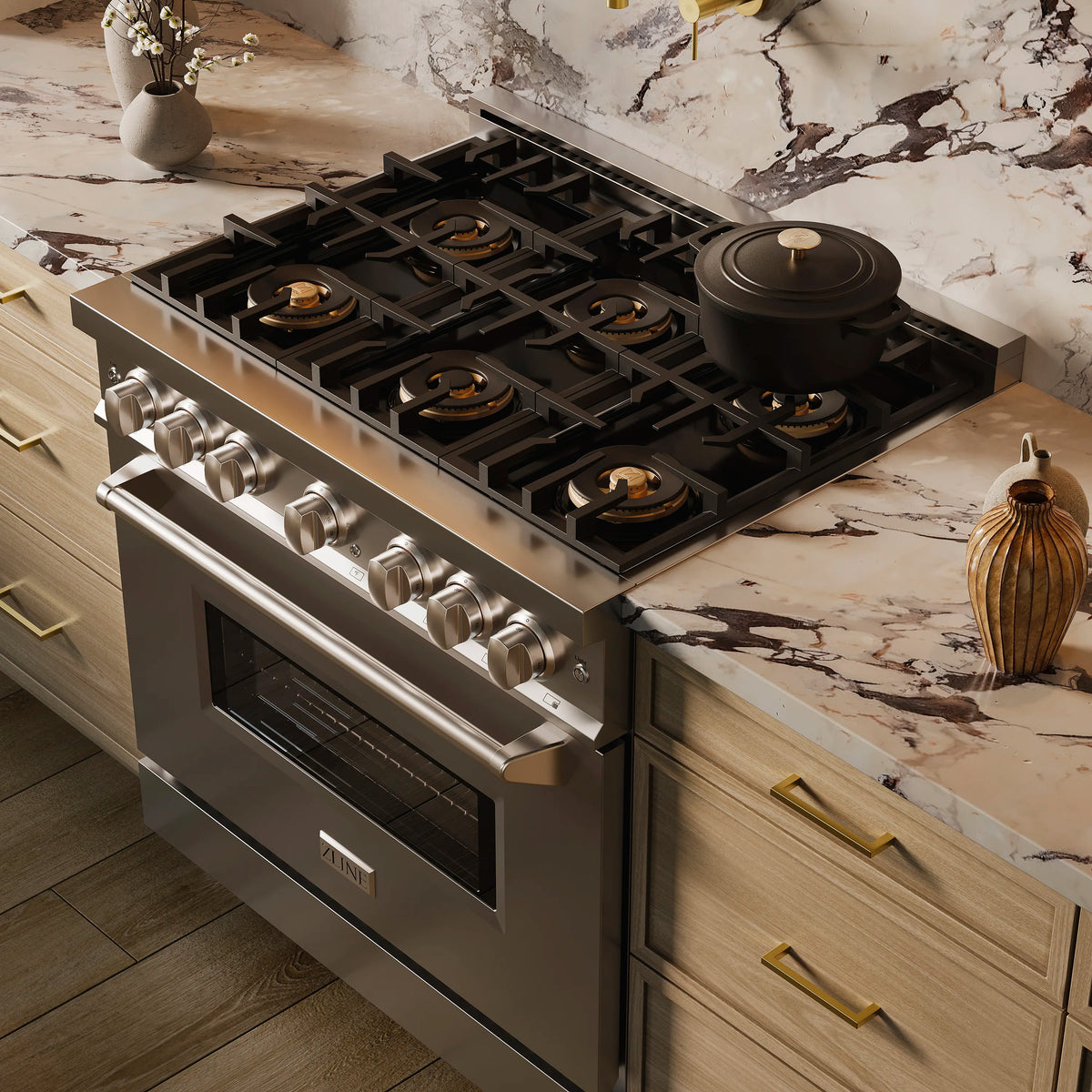 Stainless steel gas range with burner grates, knobs, and closed oven door