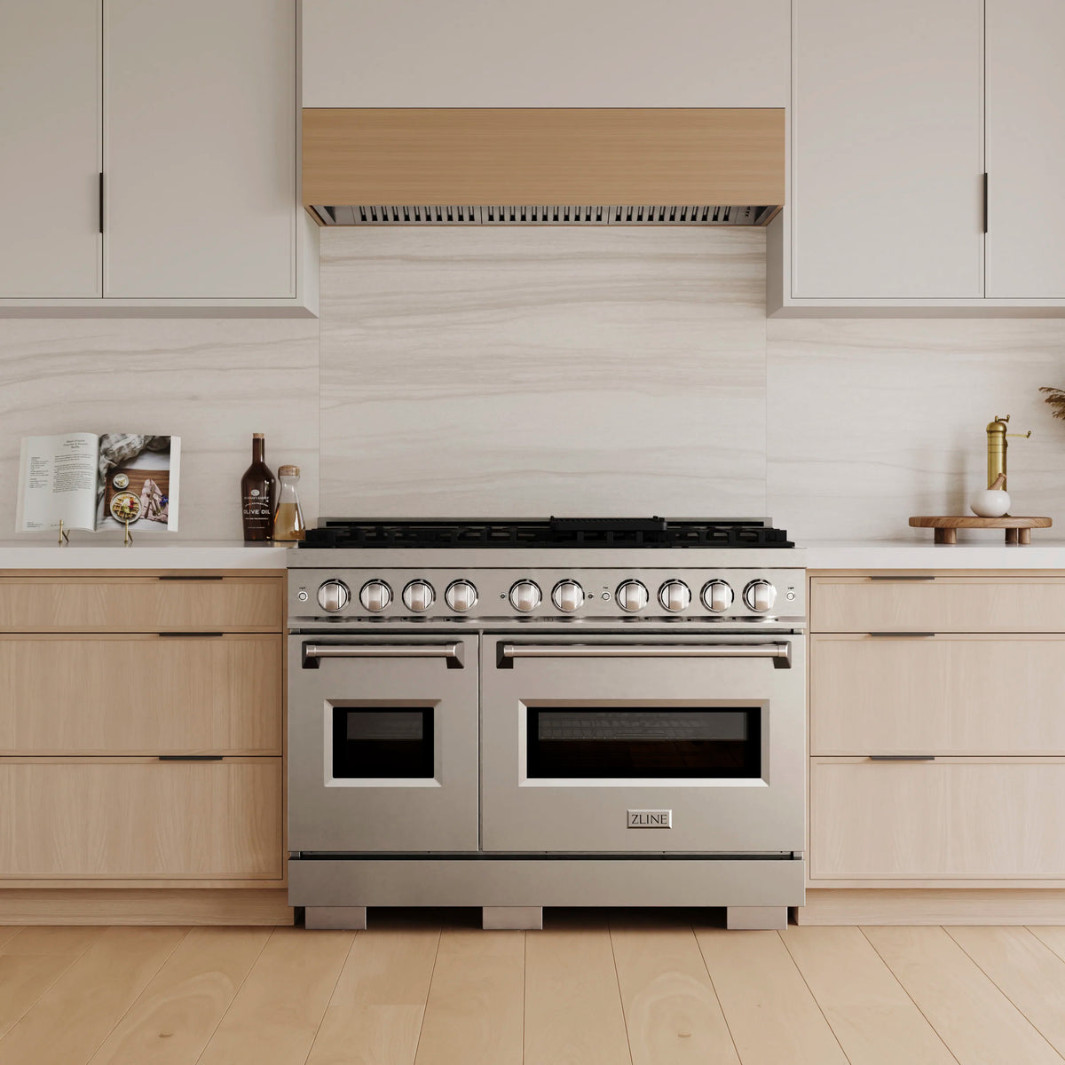 Stainless double-oven gas range with burner knobs and cooktop on front view.