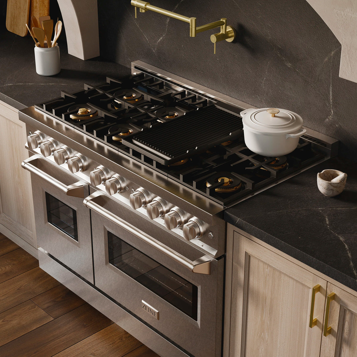 Black cooktop with multiple cast iron grates and metal burner rails