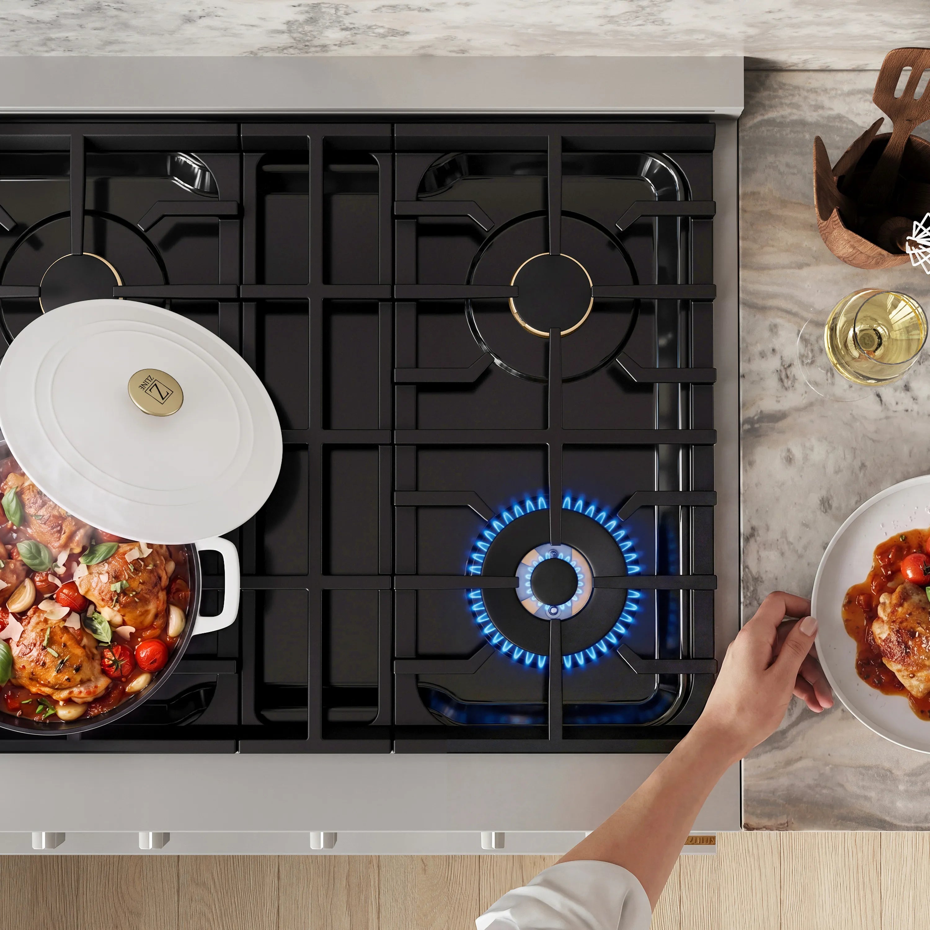 Gas range cooktop with active burner flame and two pots on grates