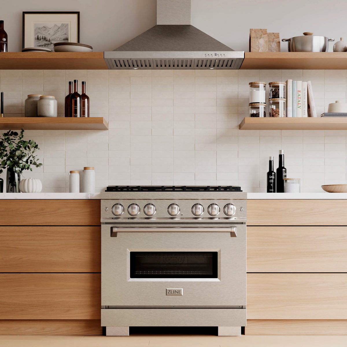 Stainless steel gas range with knob controls and black cooktop grate line