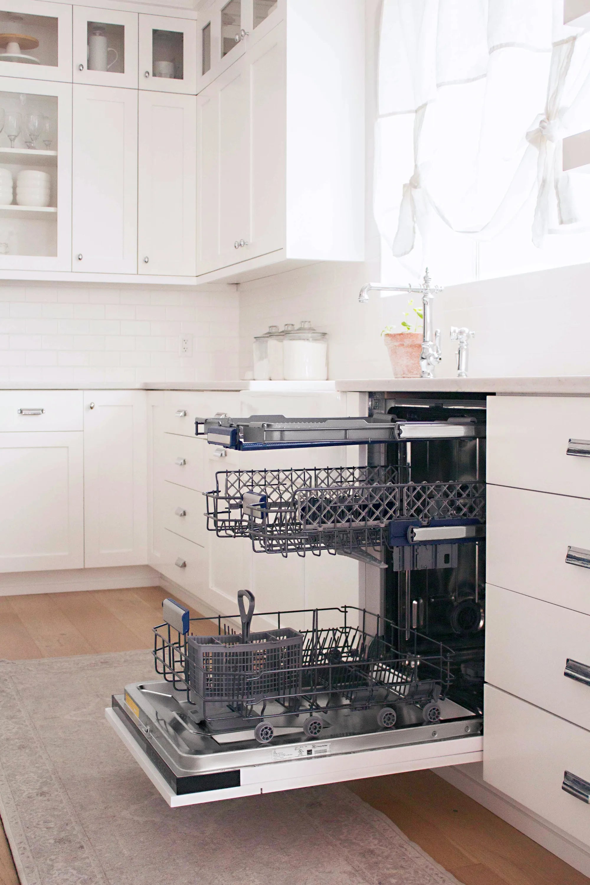 Built-in dishwasher with open door showing mid and bottom racks