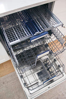 Dishwasher interior with top rack, bottom rack, and spray arms.