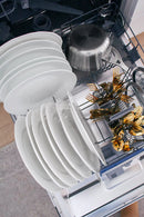 Tall built-in dishwasher racks loaded with white plates and bowls, top rack visible