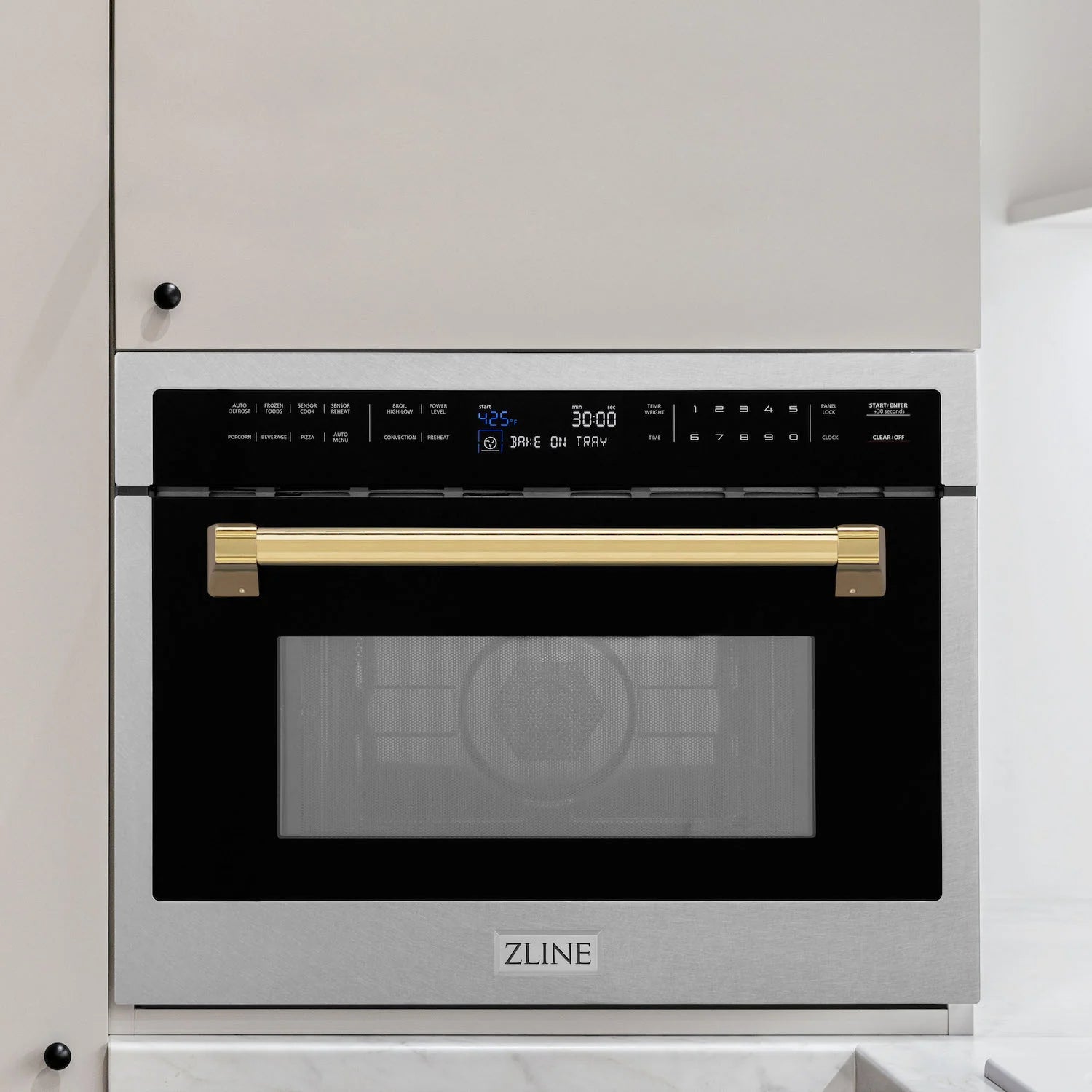 Stainless steel 24-inch microwave with gold handle and black control panel