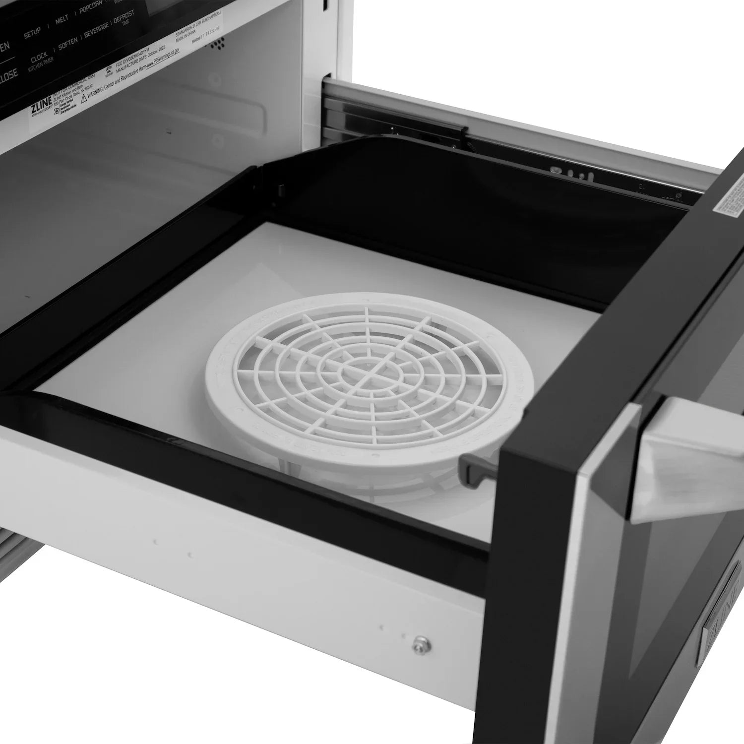 Microwave drawer interior with circular fan grate and black rails